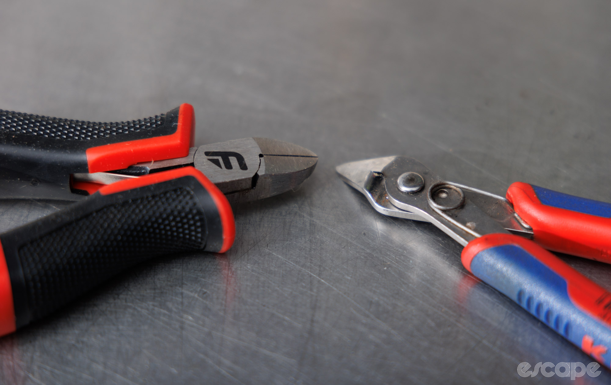 A close up of the jaws belonging to the Feedback Sports Diagonal Side cutters, compared to a Knipex flush cutter. 