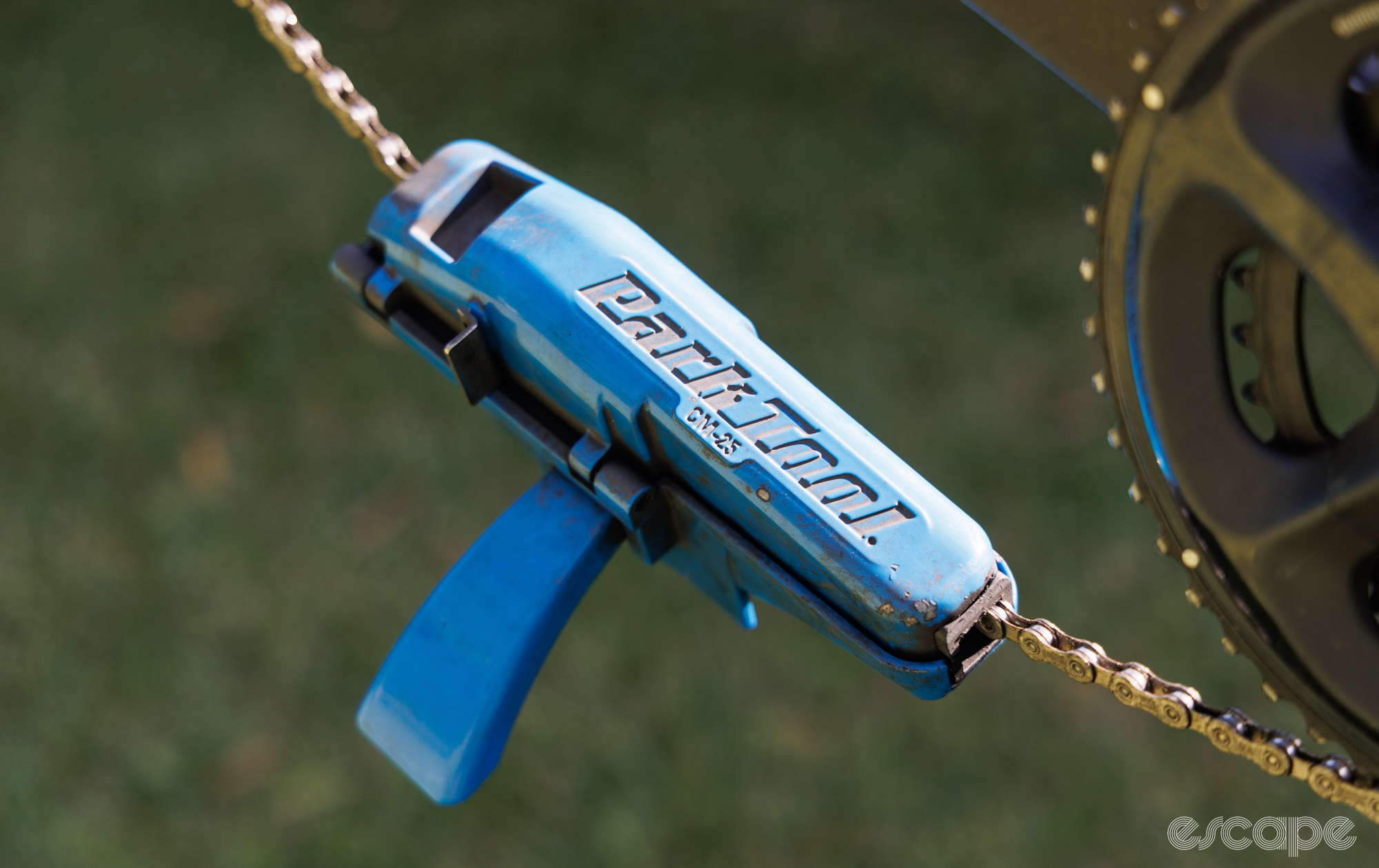 Park Tool CM-25 chain cleaner clipped onto a chain and bike. 