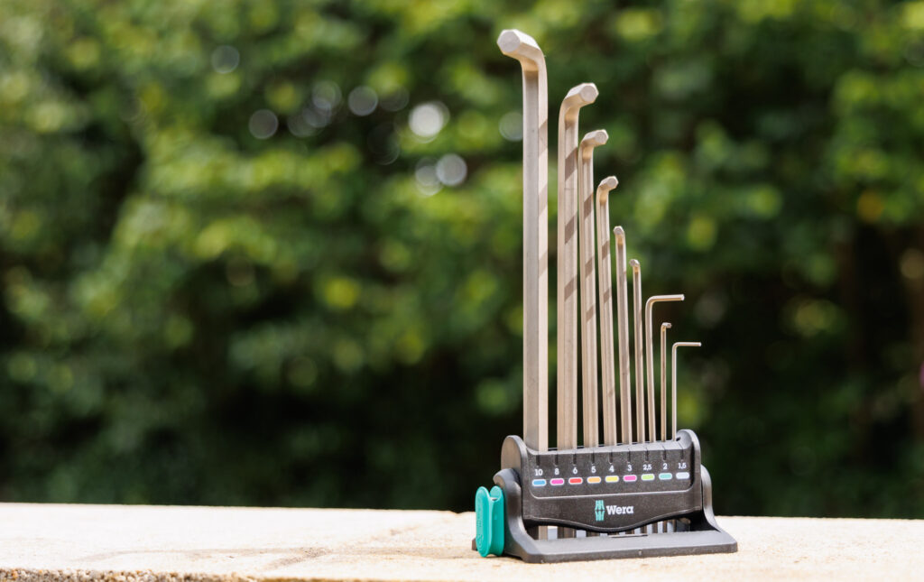 Wera hex keys sit upright on a tile in their respective holder. 