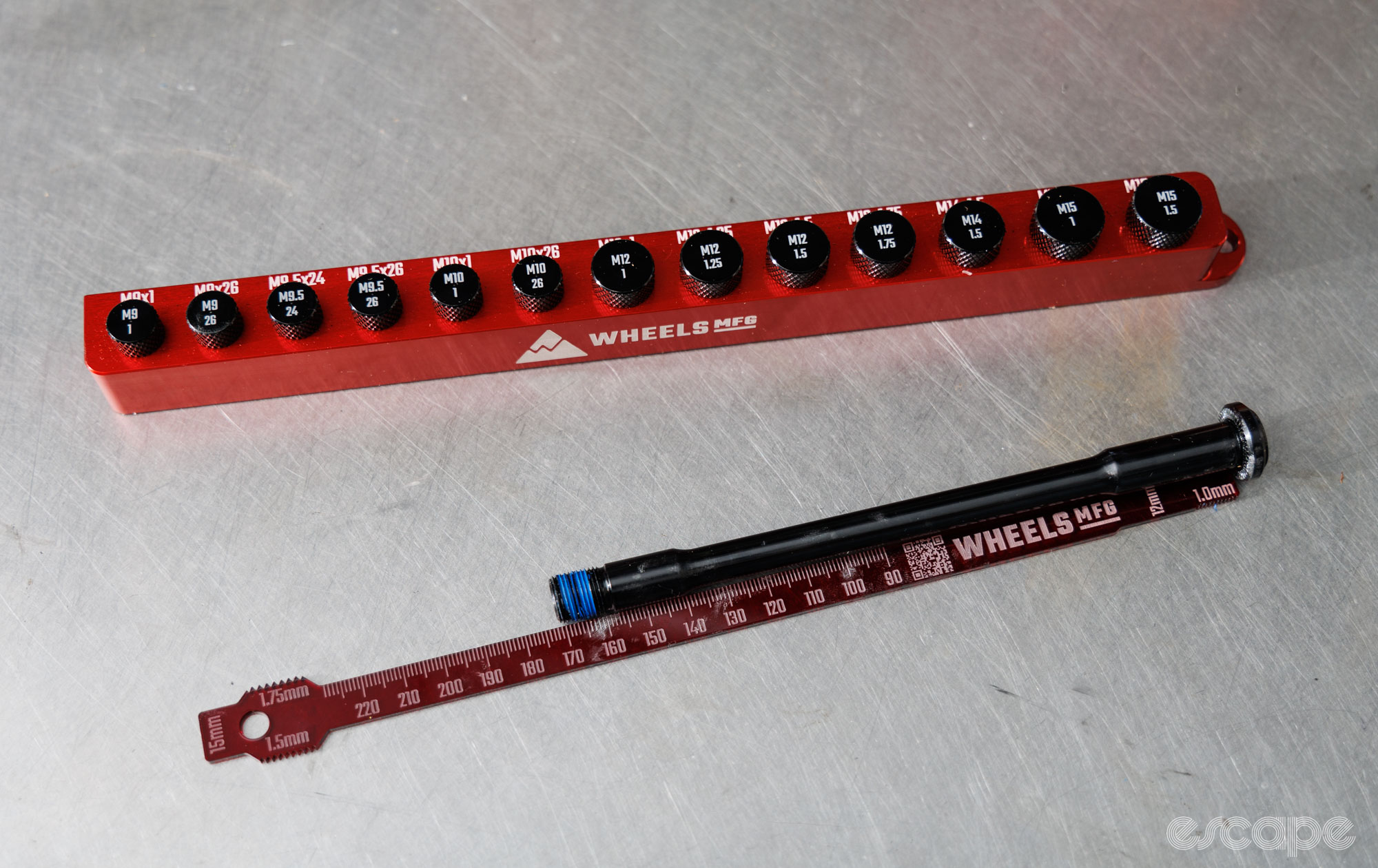 Wheels Manufacturing's Thru-Axle ruler tools on a bench. 