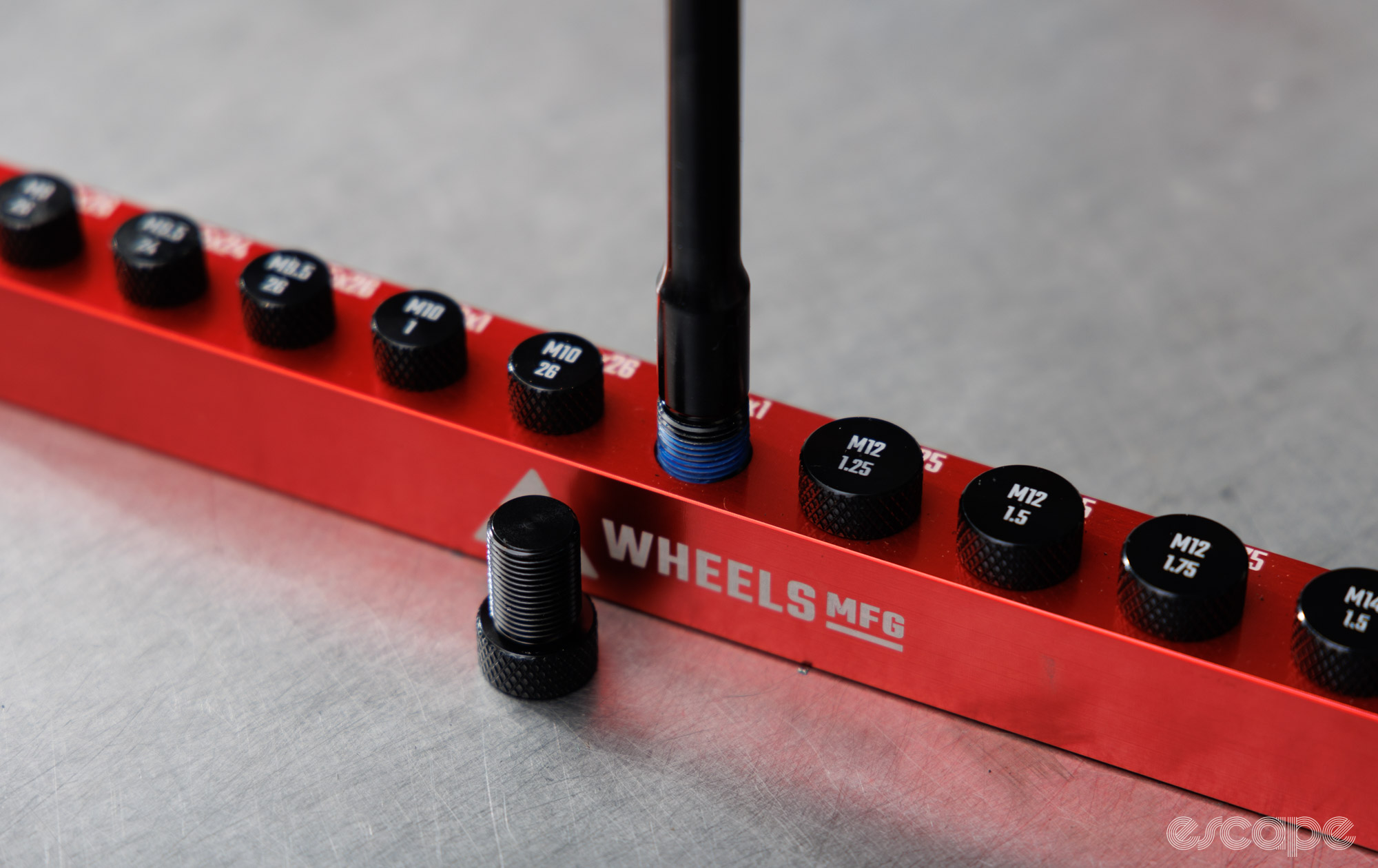 The Wheels Manufacturing Axle Ruler Pro and its threaded bits. 