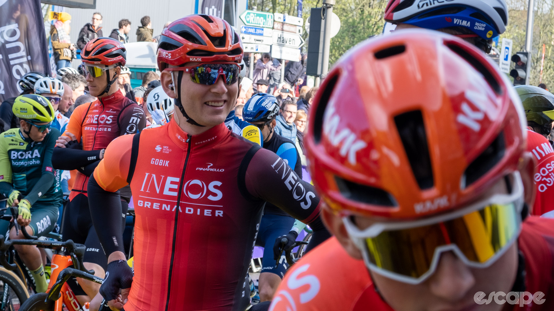 The image shows three Ineos riders with two different helmets. 