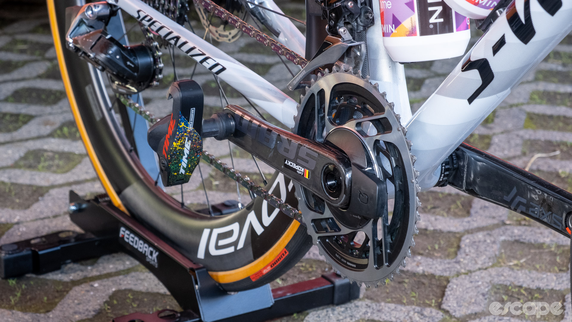 The photo shows Time pedals with a rainbow themed paint job on the pedal body and a crankset with her name sticker on the crank arm.