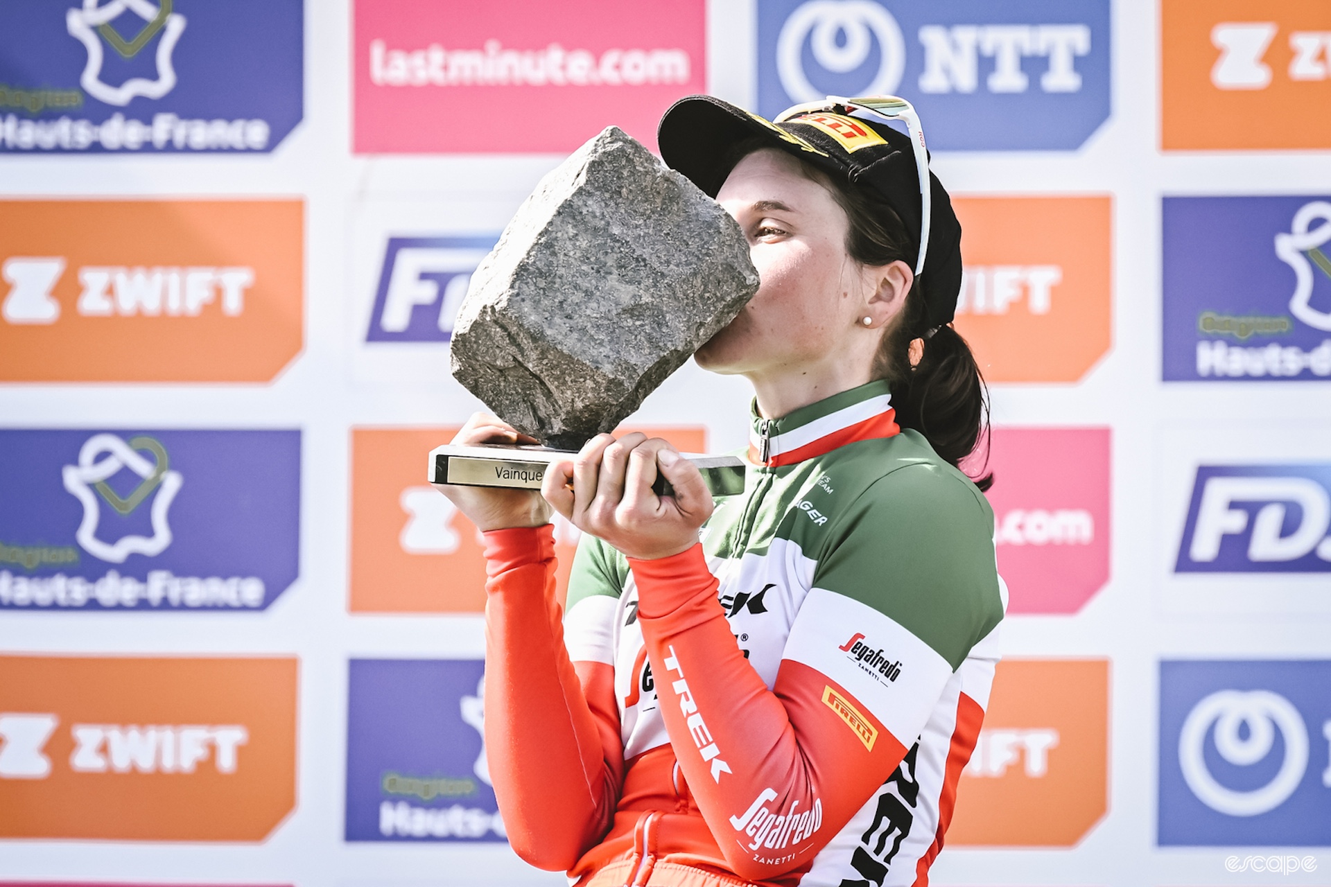 Elisa Longo Borghini kisses her Paris-Rouabix cobble after winning the race in 2022. 