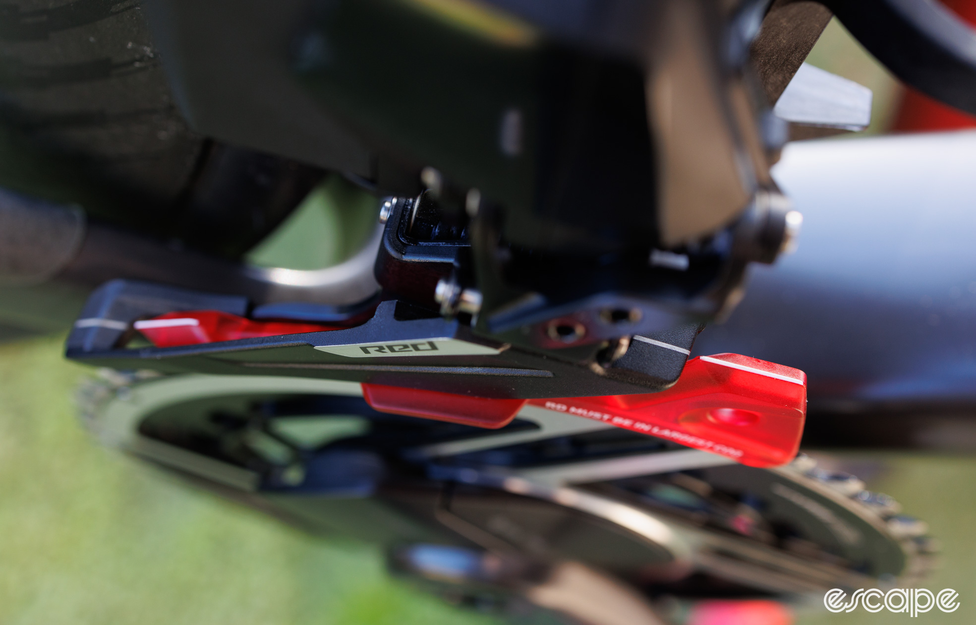 A plastic derailleur alignment tool is inserted into the new SRAM Red AXS front derailleur. Shown from the top. 