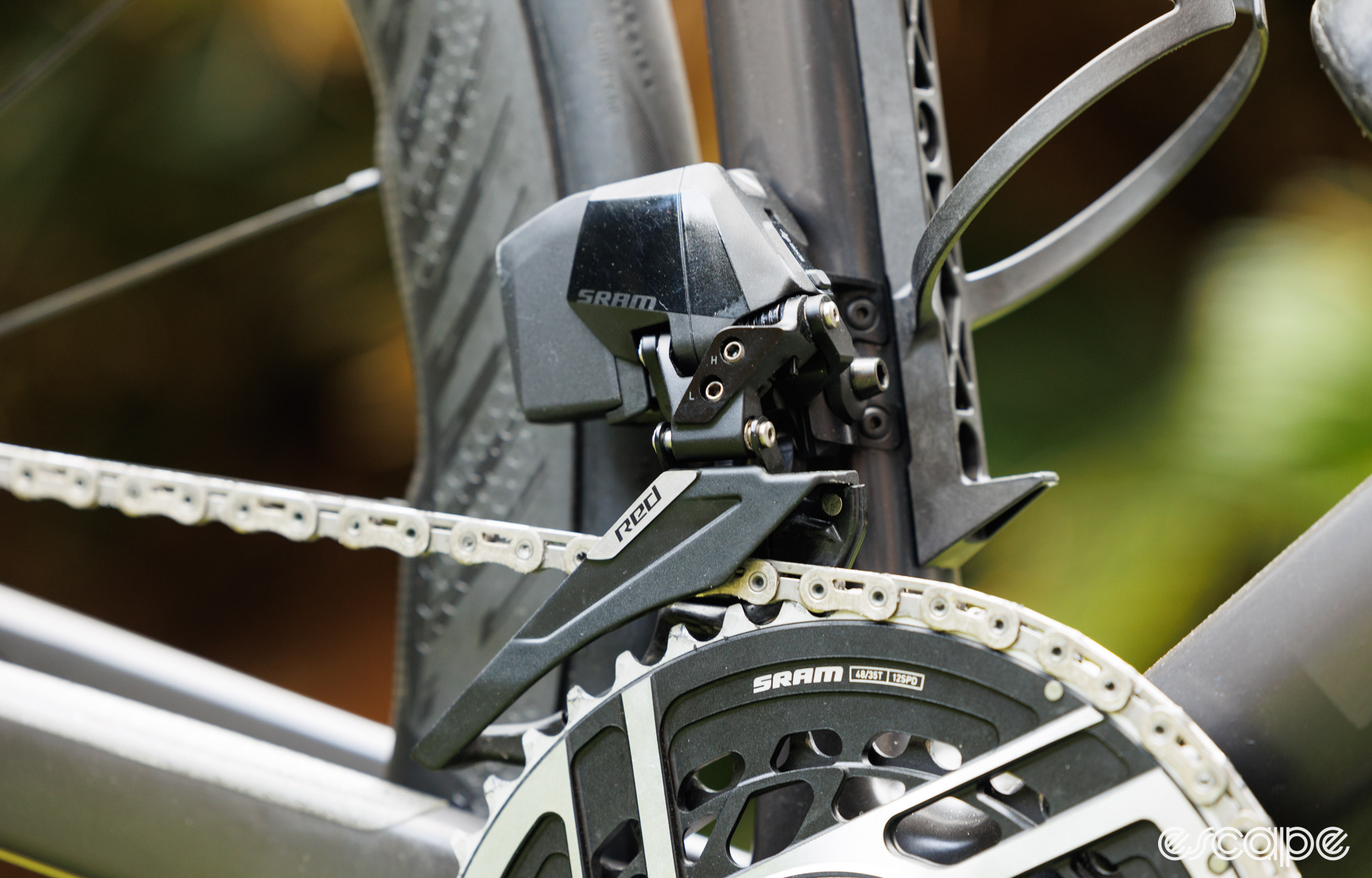 SRAM Red AXS front derailleur on a bike with the chain and crank in view. 