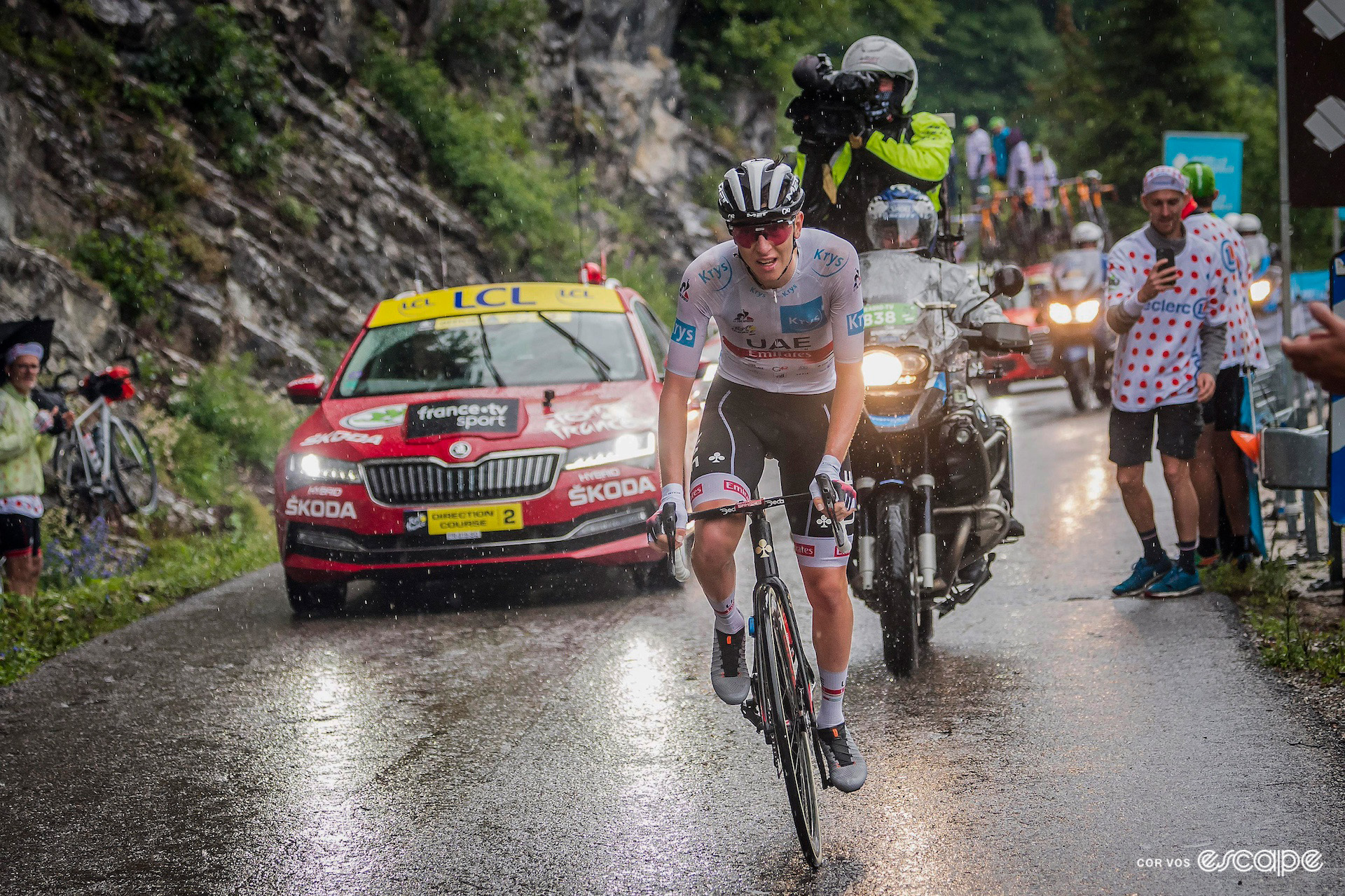 Tadej Pogačar in the white jersey of best young rider soaked through in the rain during stage 8 of the 2021 Tour de France.