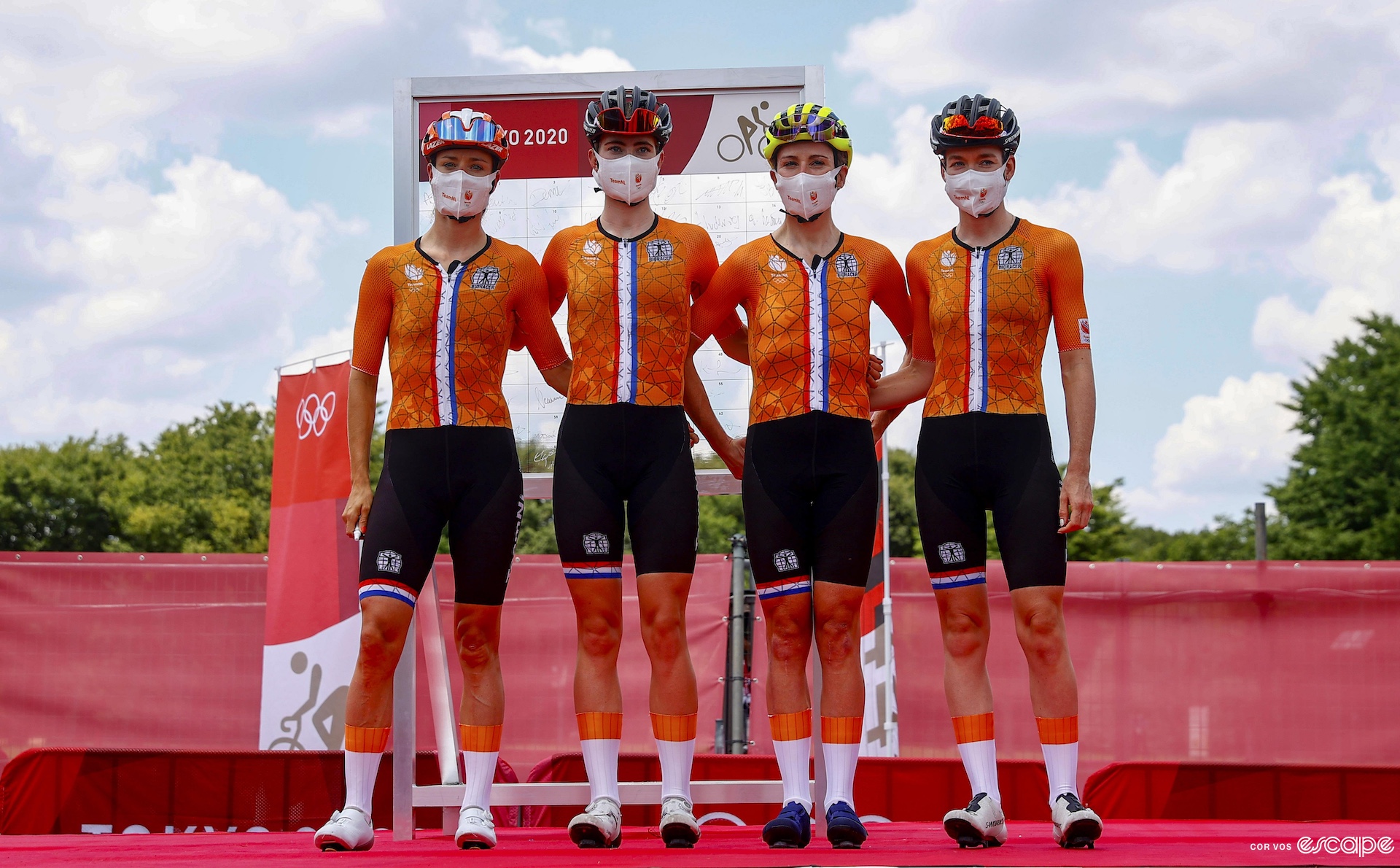 Marianne Vos, Demi Vollering, Annemiek Van Vleuten and Anna Van Der Breggen stand on a stage in kit before the Olympic road race in Tokyo 