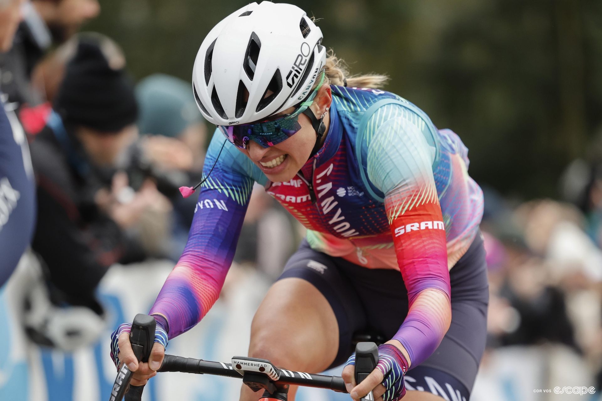 Kasia Niewiadoma grits her teeth during a bike race as she rides alone up a climb