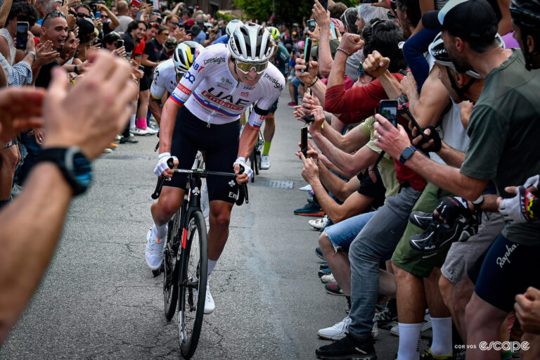 Tadej Pogačar climbs through a crowd during stage 1 of the Giro d'Italia.