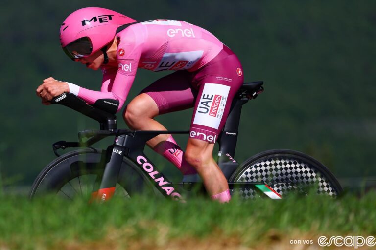 Tadej Pogačar time trials at the Giro d'Italia. He's in an efficient aero tuck as the landscape blurs around him.