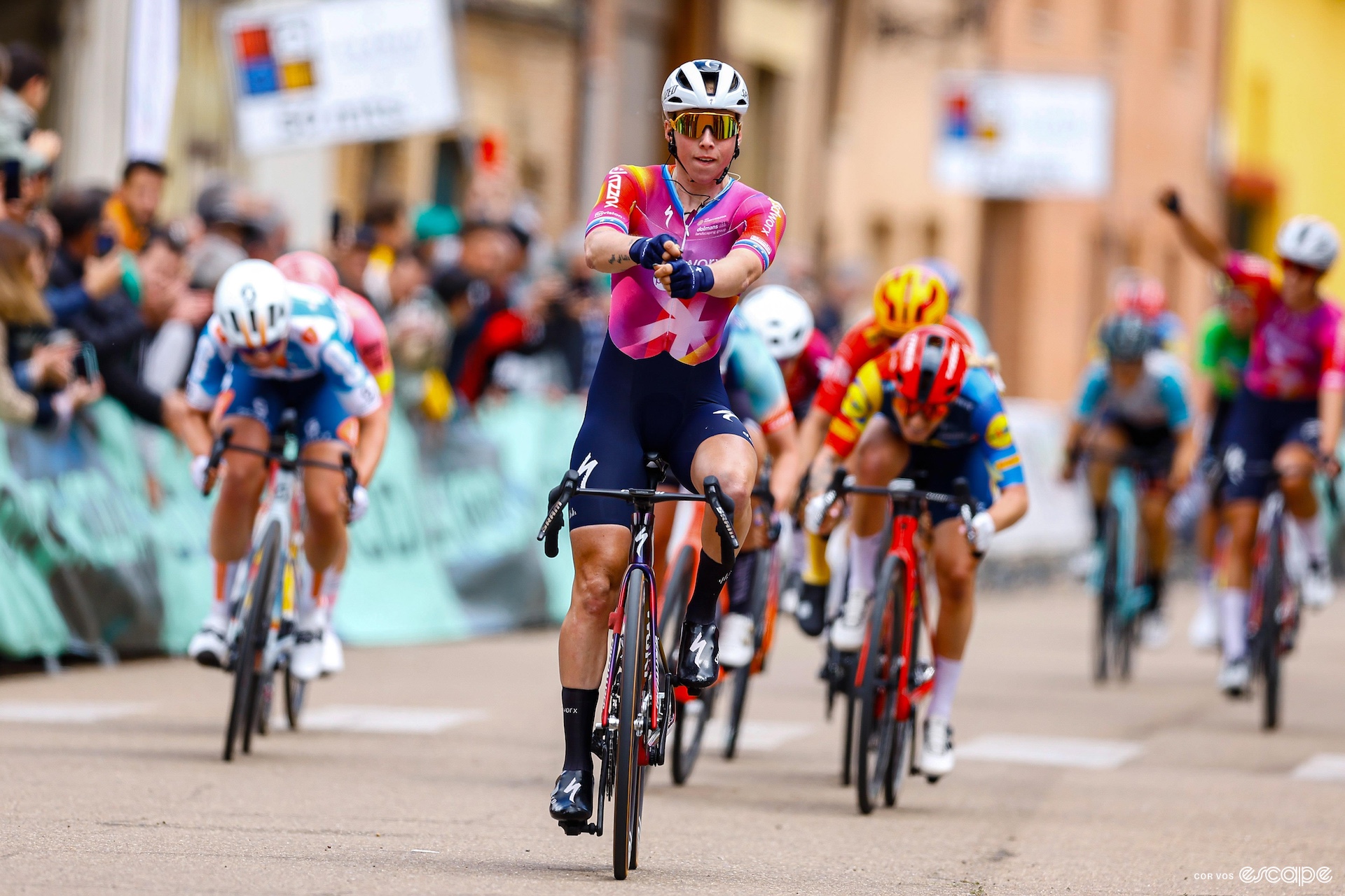 Lorena Wiebes shoots an arrow from an imaginary bow as she wins the third stage of Vuelta a Burgos.