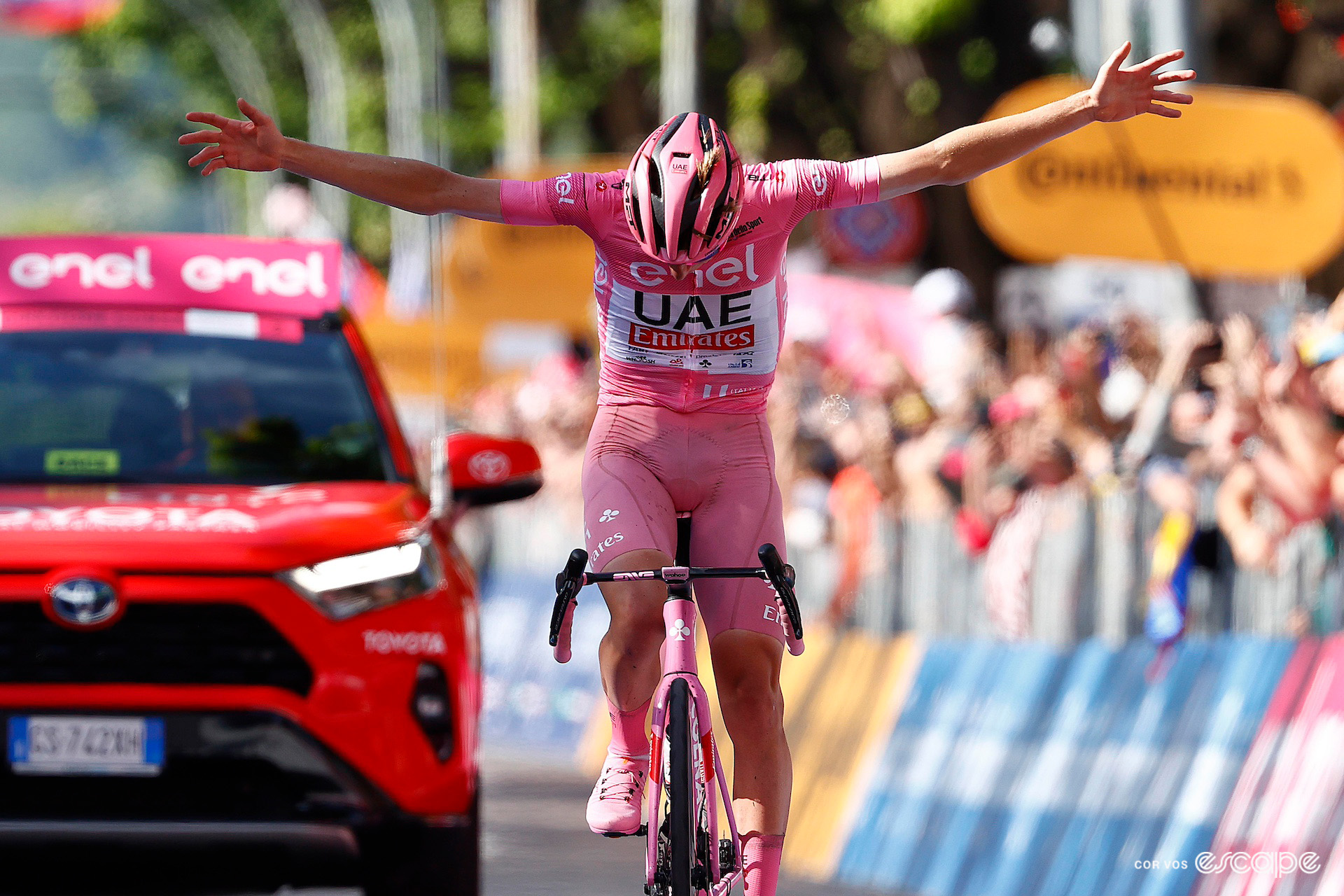 Tadej Pogačar in pink bows as he celebrates winning stage 20 of the 2024 Giro d'Italia.