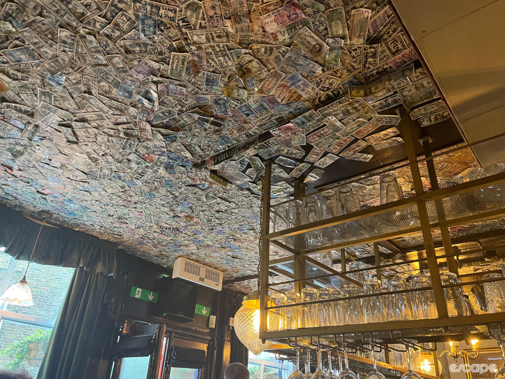 The interior of the Grenadier pub in West London with money stuck to the ceiling.