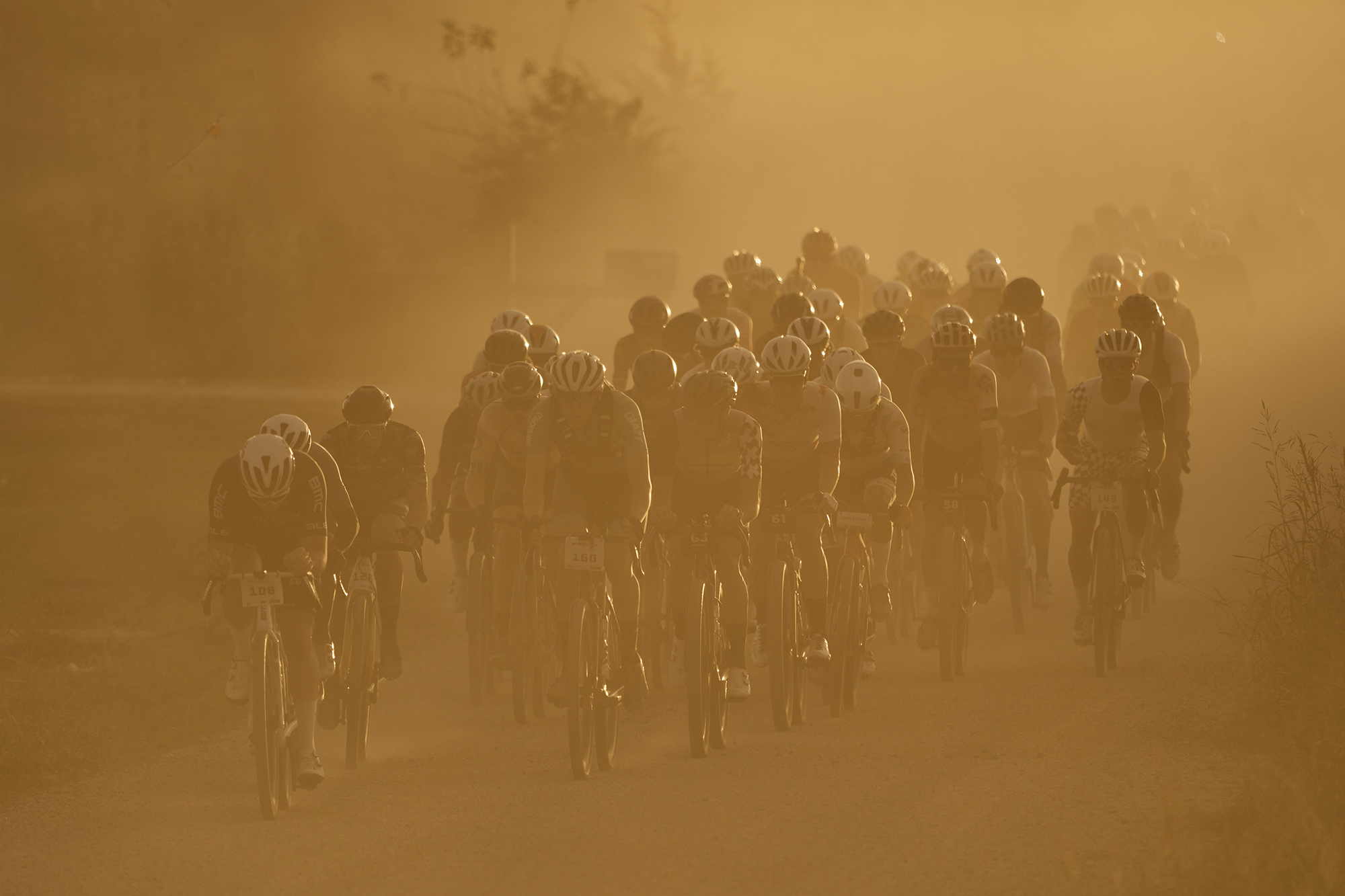 Riders plow on through dust clouds.