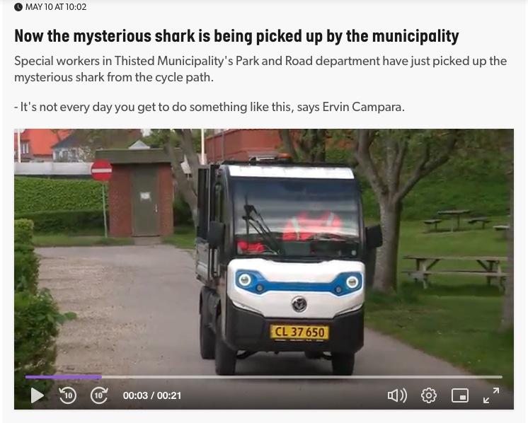 Screenshot of news report showing a council worker arriving in a funny little van to collect the bag of shark. 