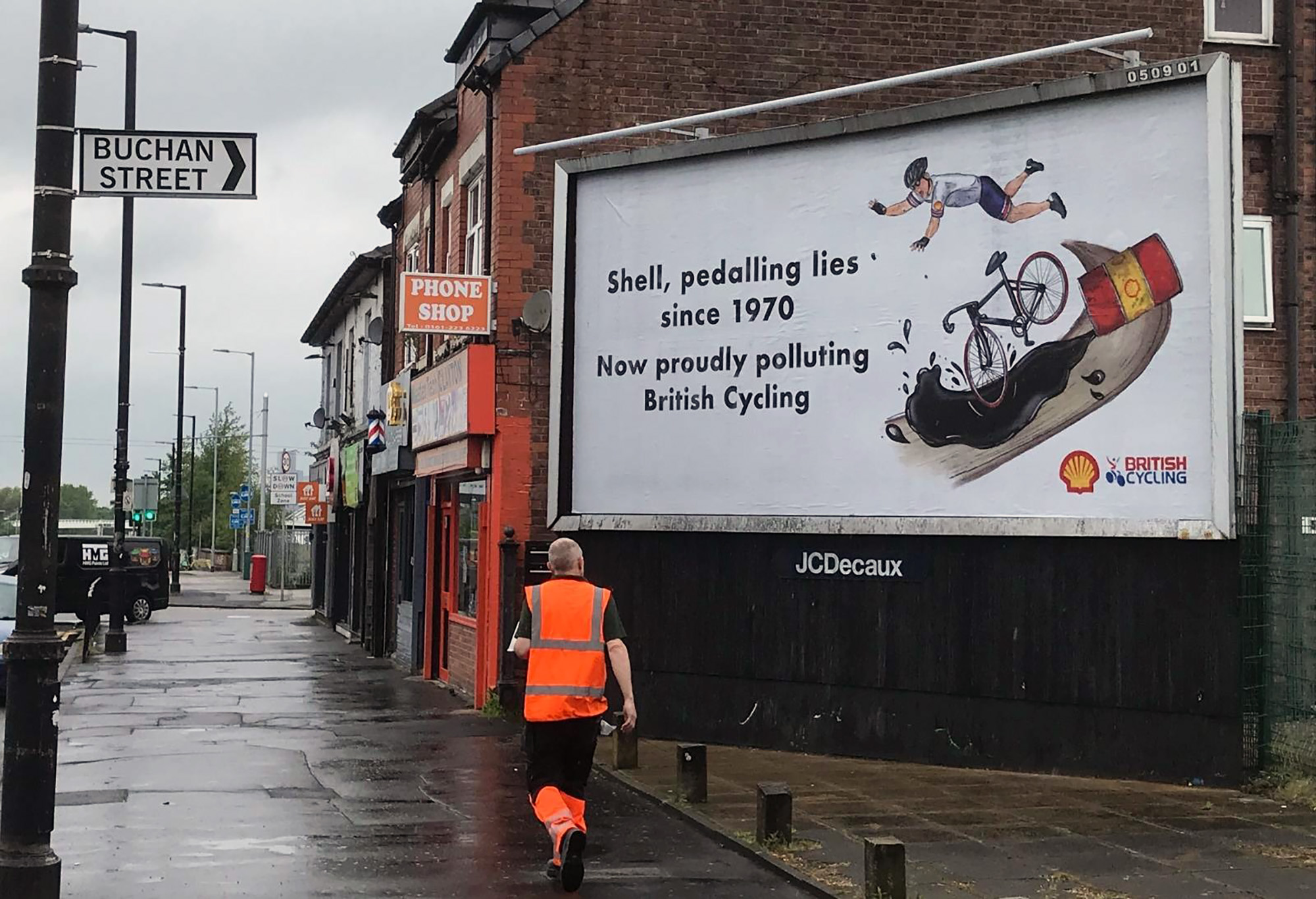 A billboard showing a poster protesting Shell and its sponsorship of British Cycling.