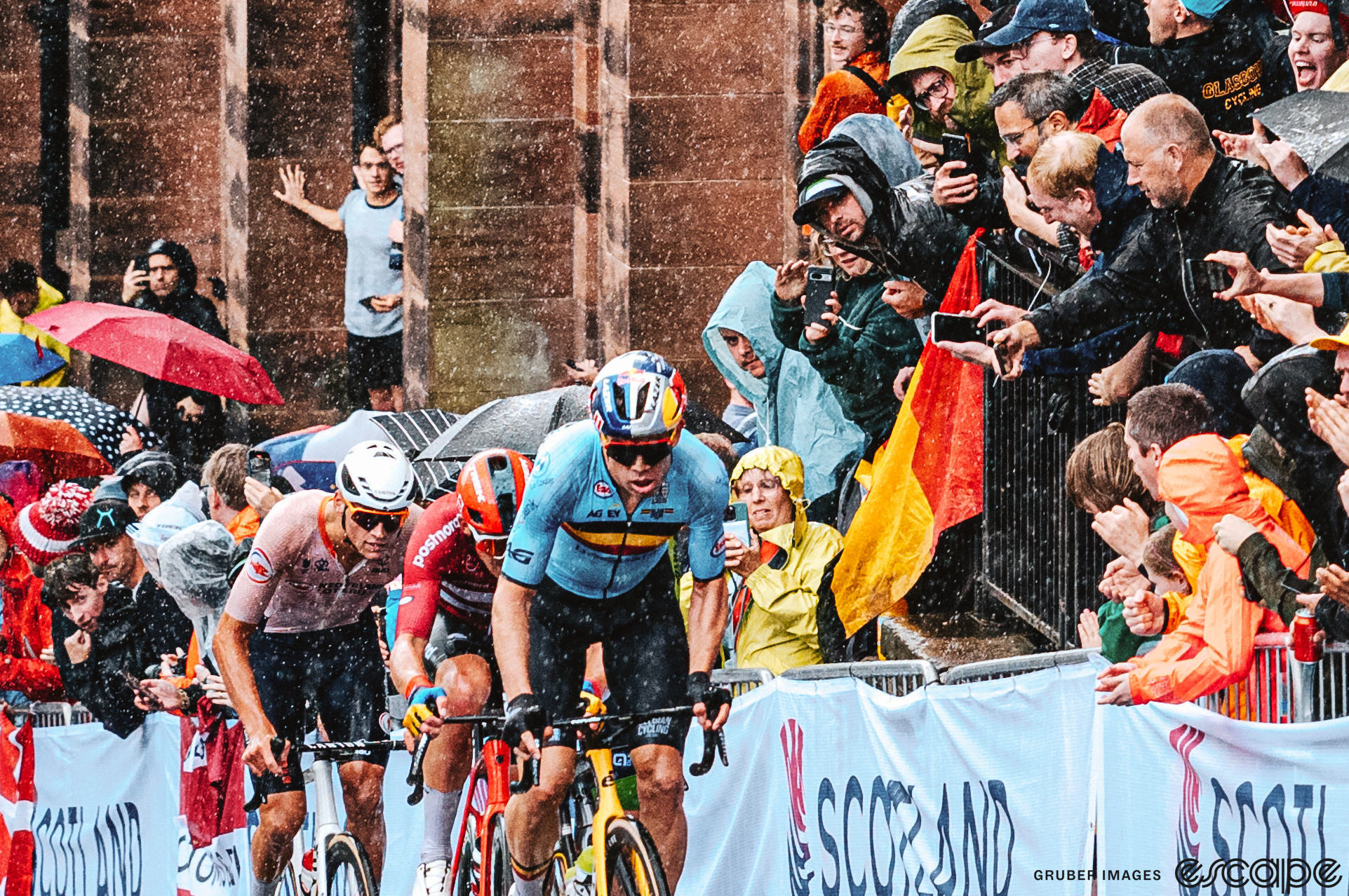 Wout van Aert leads Mads Pedersen and Mathieu van der Poel up a climb in the rain at the 2023 World Road Championships in Glasgow, Scotland.