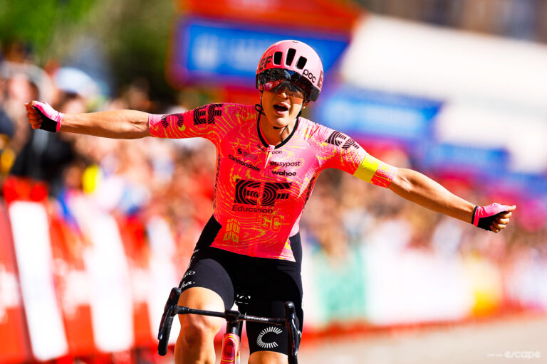 Kristen Faulkner raises her arms in victory as she soloes to the win in stage 5 of La Vuelta Femenina.