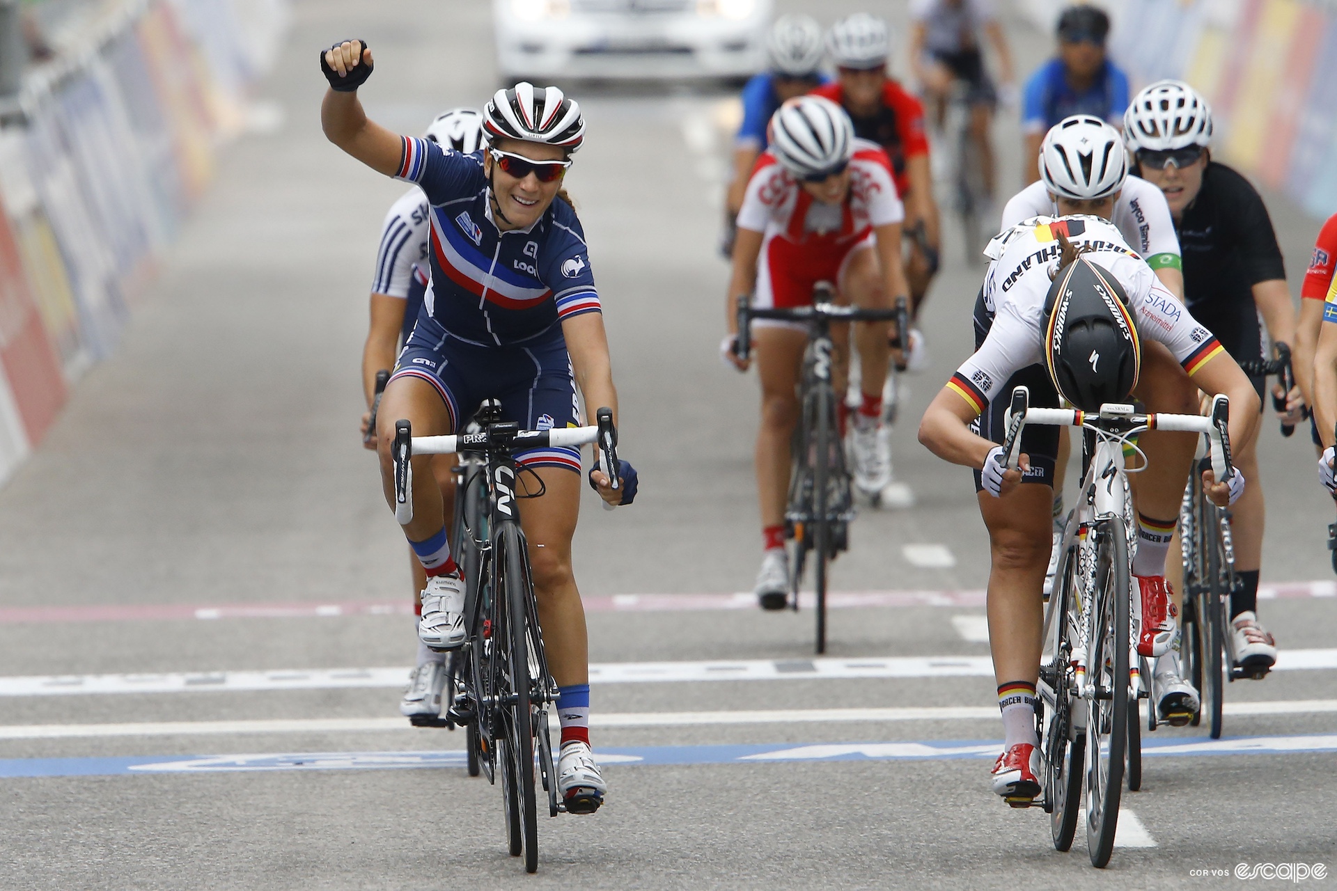 Pauline Ferrand Prevot raises her arm in victory after winning the 2014 road world title.