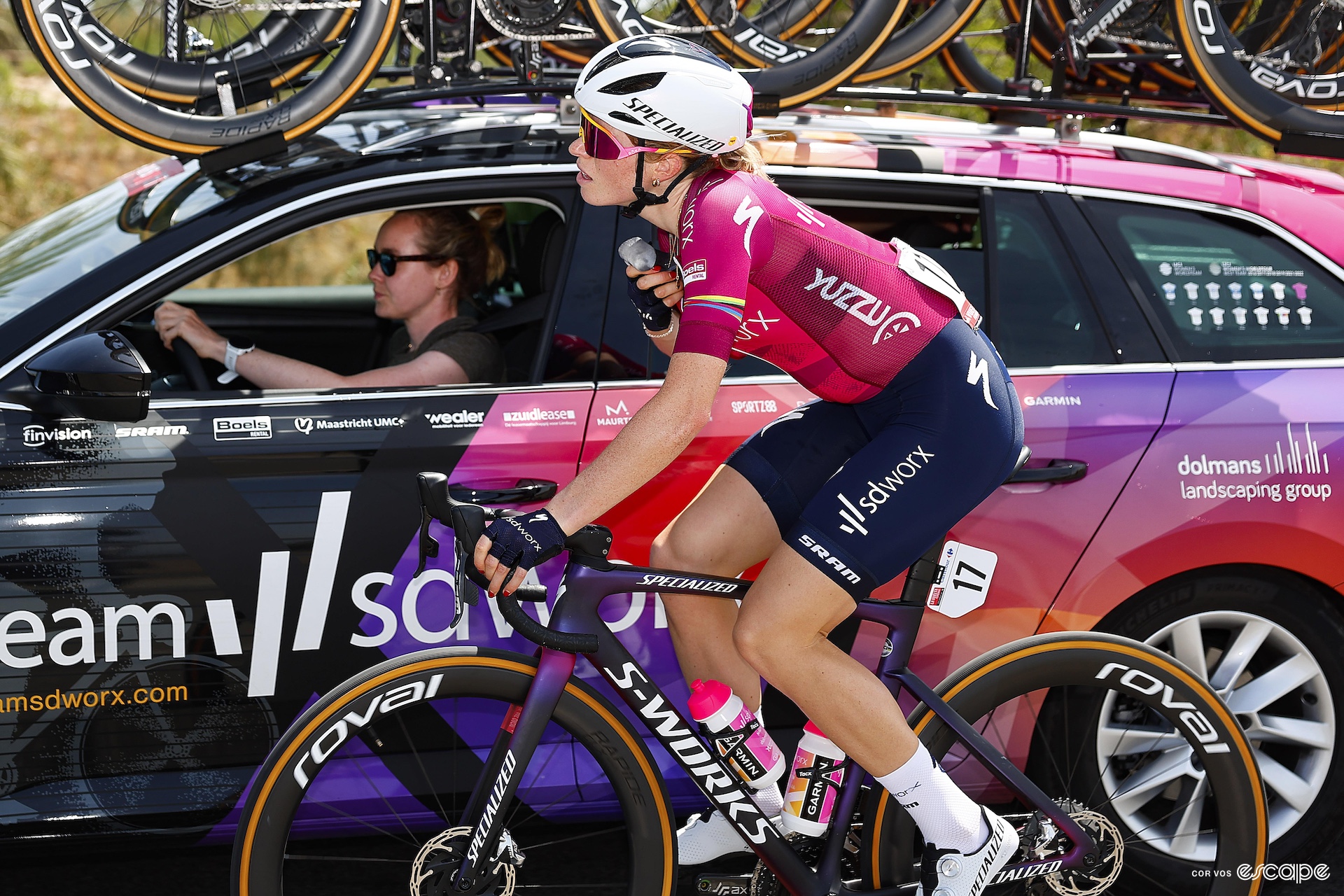 Van der Breggen drives the team car alongside Vollering on her bike 