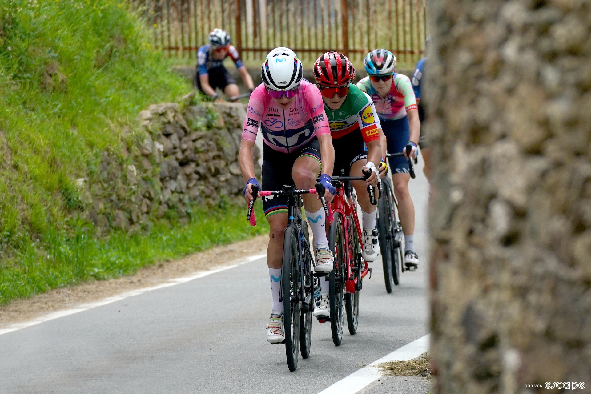 Annemiek van Vlueten leads a select group of riders while wearing the pink jersey.