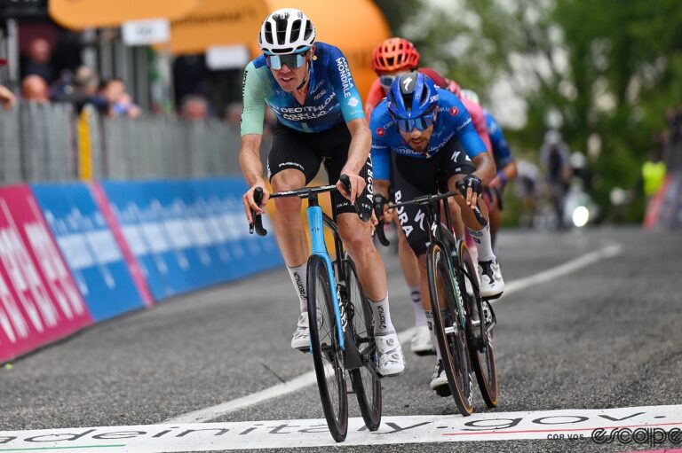 Ben O'Connor leads Filippo Ganna across the finish line during a stage of the 2024 Giro d'Italia.