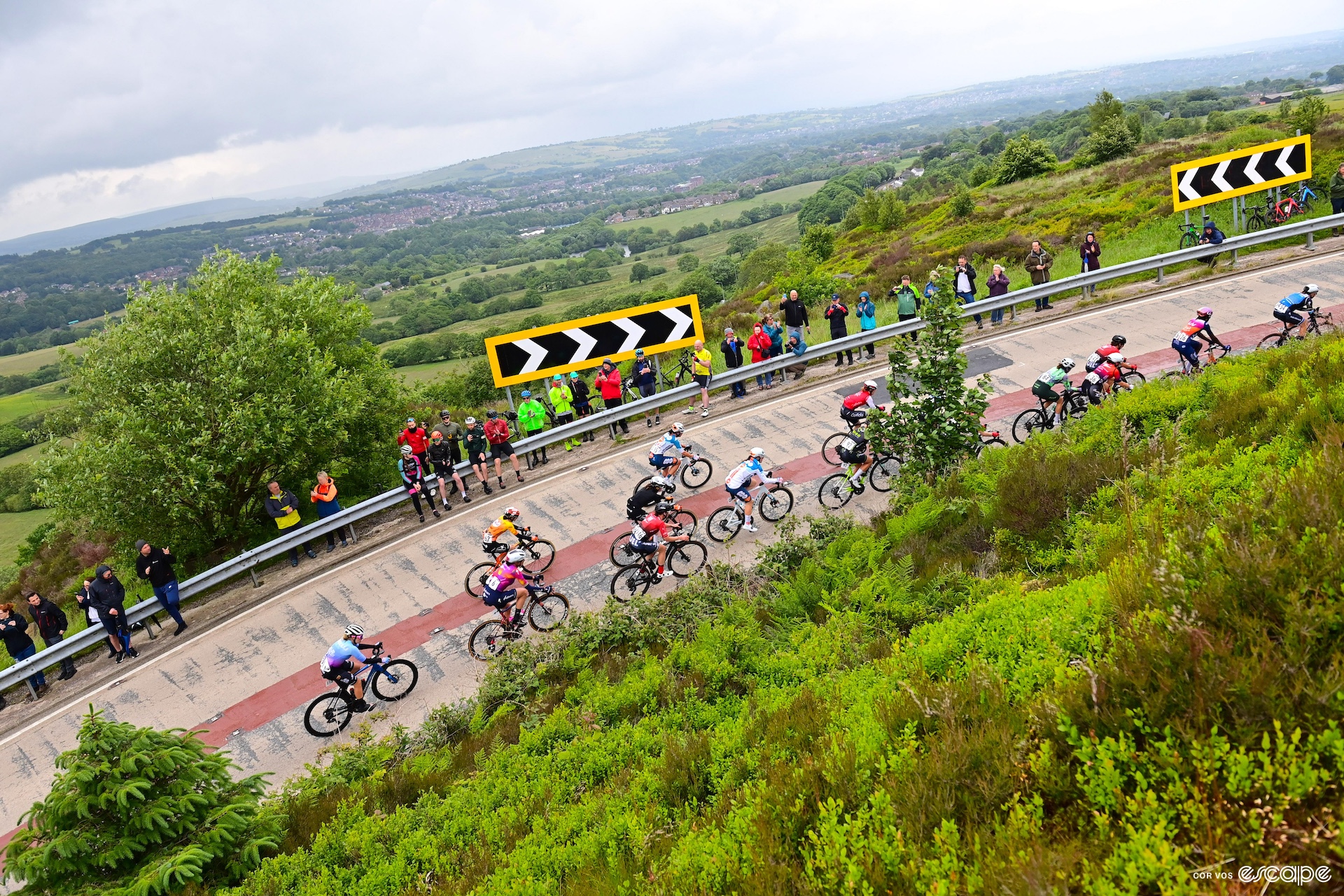 The women's peloton strung out as the ride up a climb in the UK.