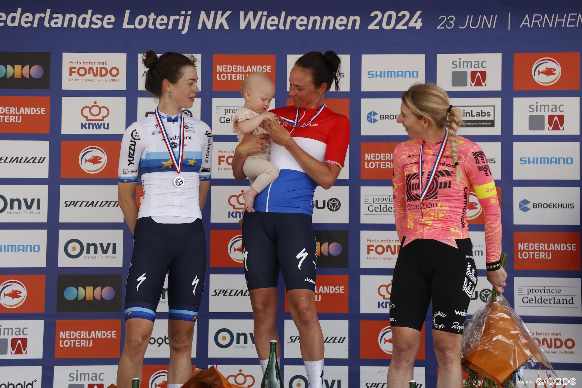 Chantal van den Broek-Blaak holds her daughter Noa on the podium of the Dutch nationals