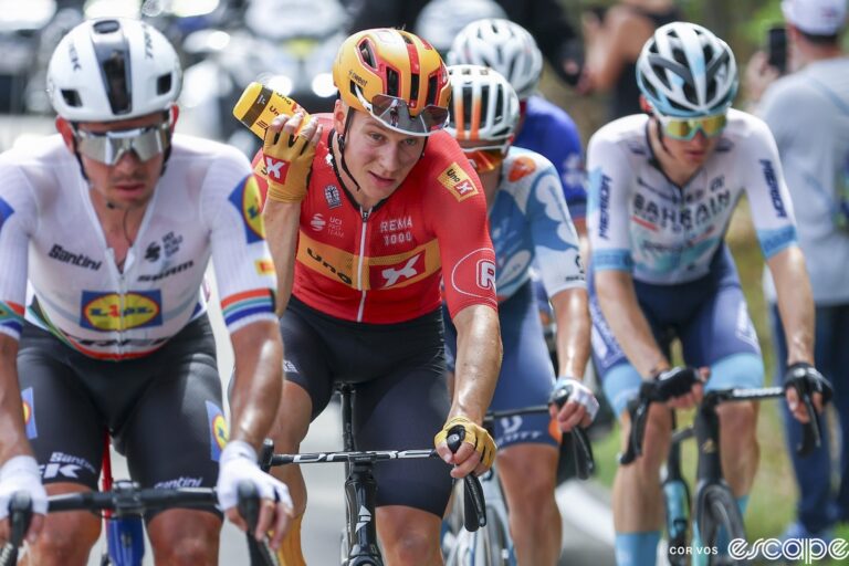 Jonas Abahamsen sprays water on his face and neck during stage 1 of the 2024 Tour de France.