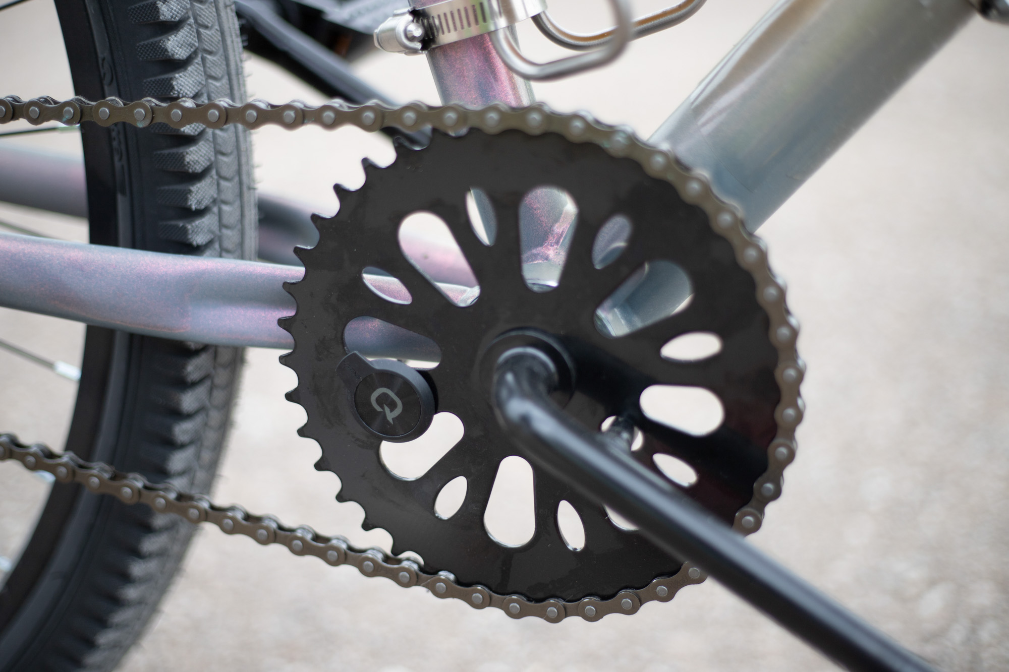 A Quarq power meter cover is glued to a steel crankset.