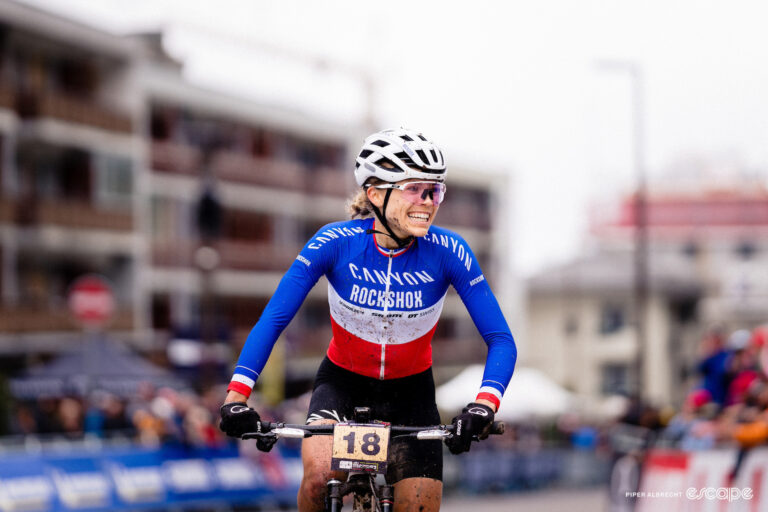 French national champion Loana Lecomte grins on taking XCO victory at MTB World Cup Crans-Montana in Switzerland.