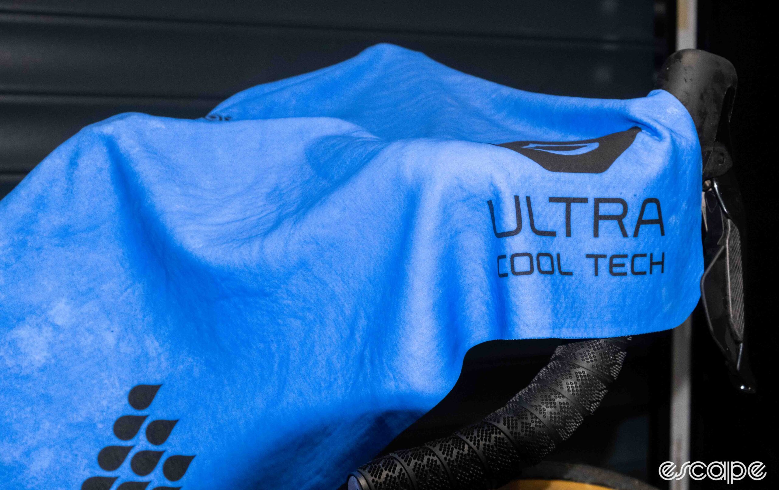 The image shows the Ultra Cool Tech towel on a handlebar