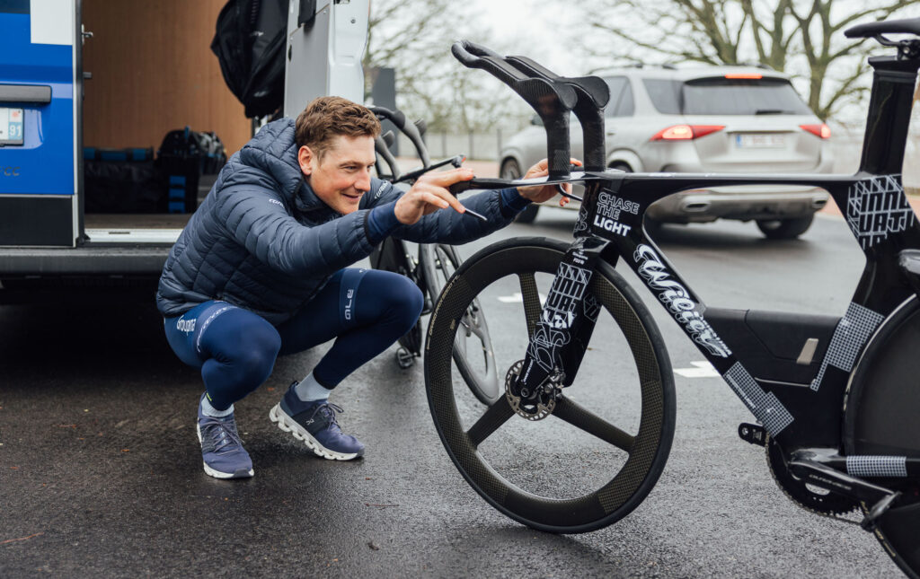 The image shows Stefan Kung checking out the new bike.