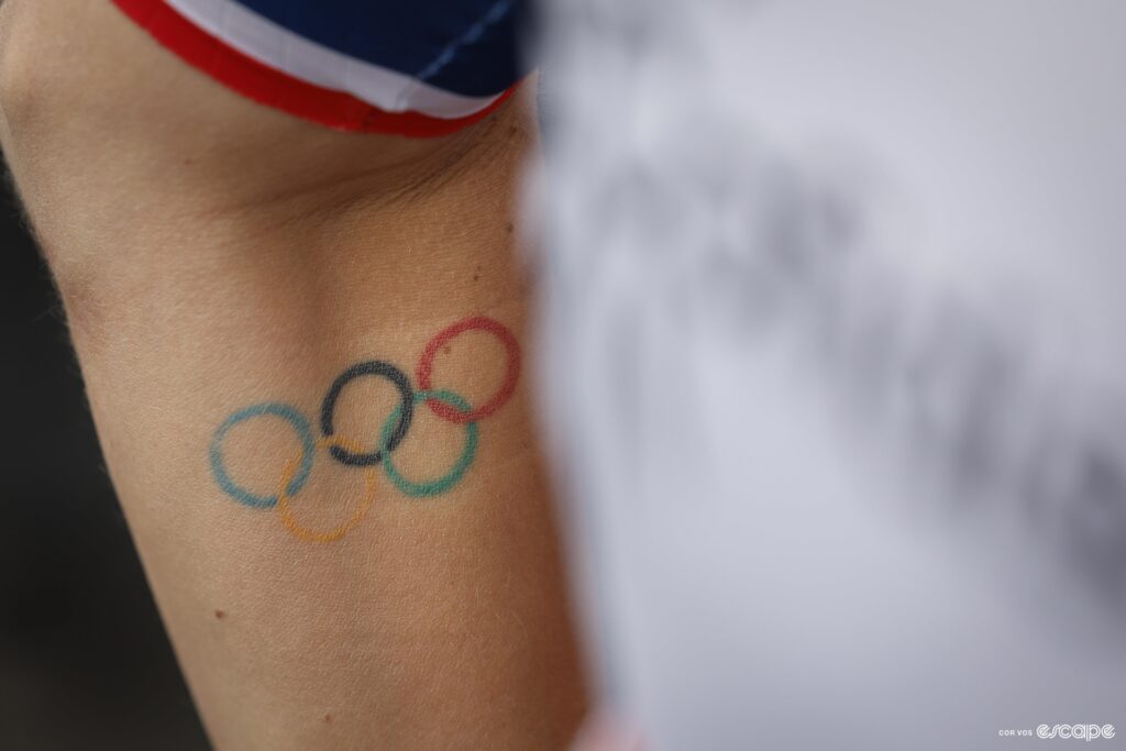 A close up of someones arm with an Olympic rings tattoo