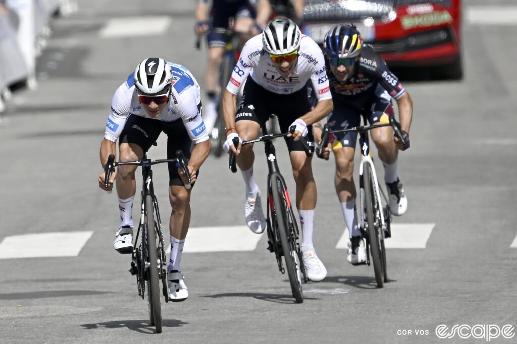 Remco Evenepoel leads Juan Ayuso and Primož Roglič over the line on stage 4 of the 2024 Tour de France. They're all out of the saddle sprinting.