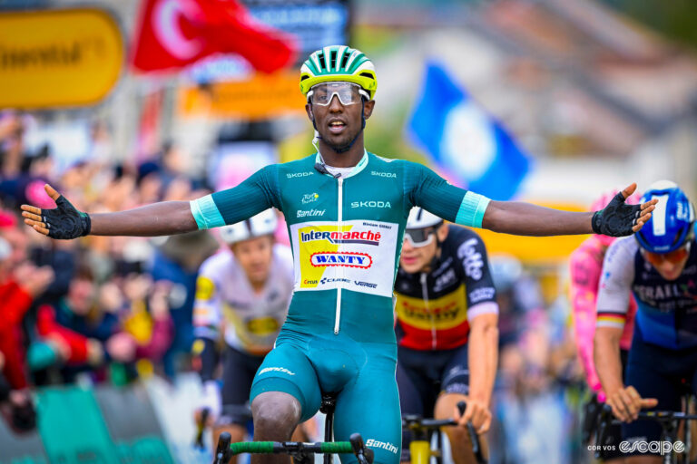 Biniam Girmay in the green jersey of points classification leader celebrates stage 8 victory at the 2024 Tour de France.