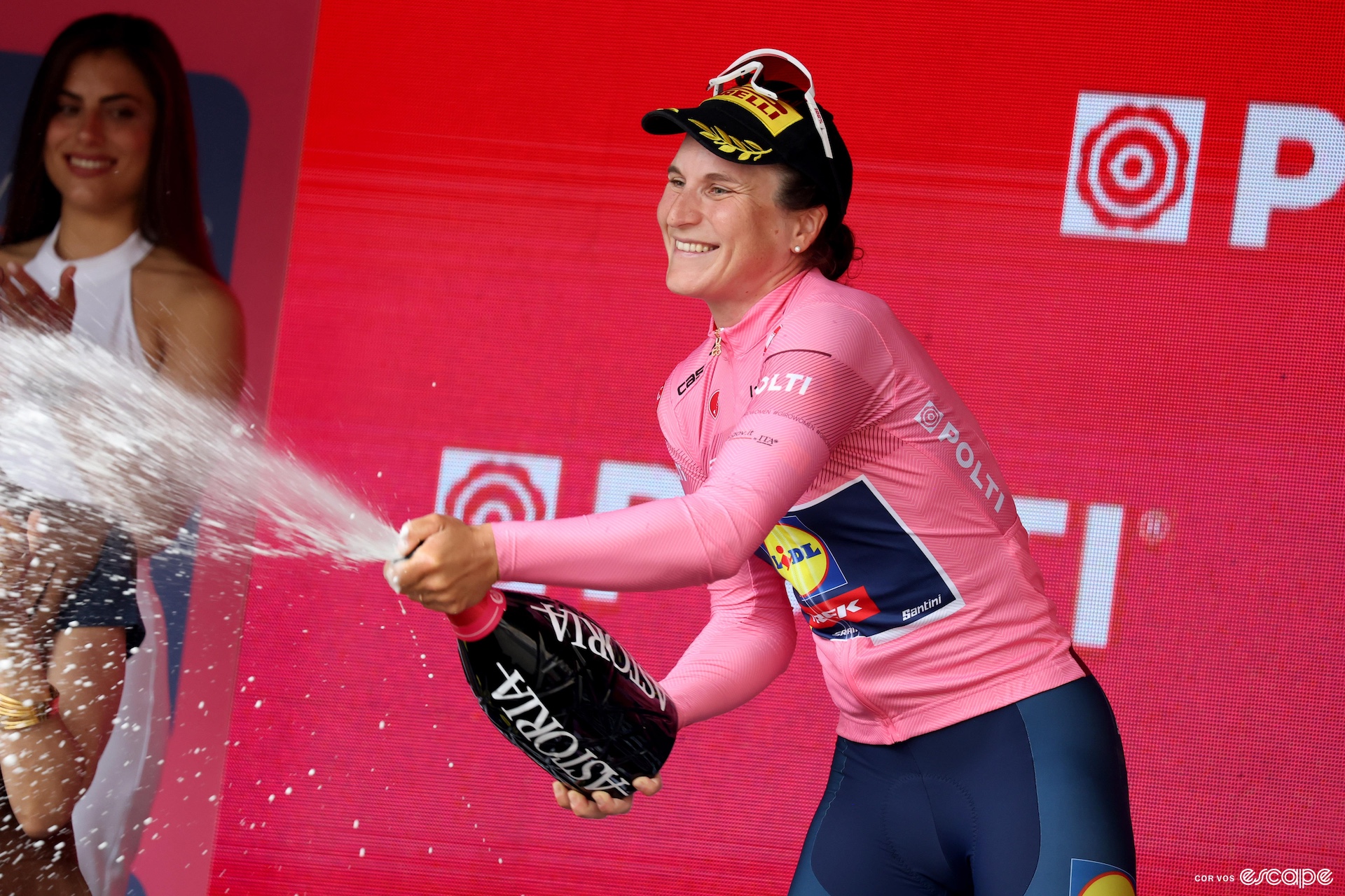 Elisa Longo Borghini sprays prosecco in the pink jersey 