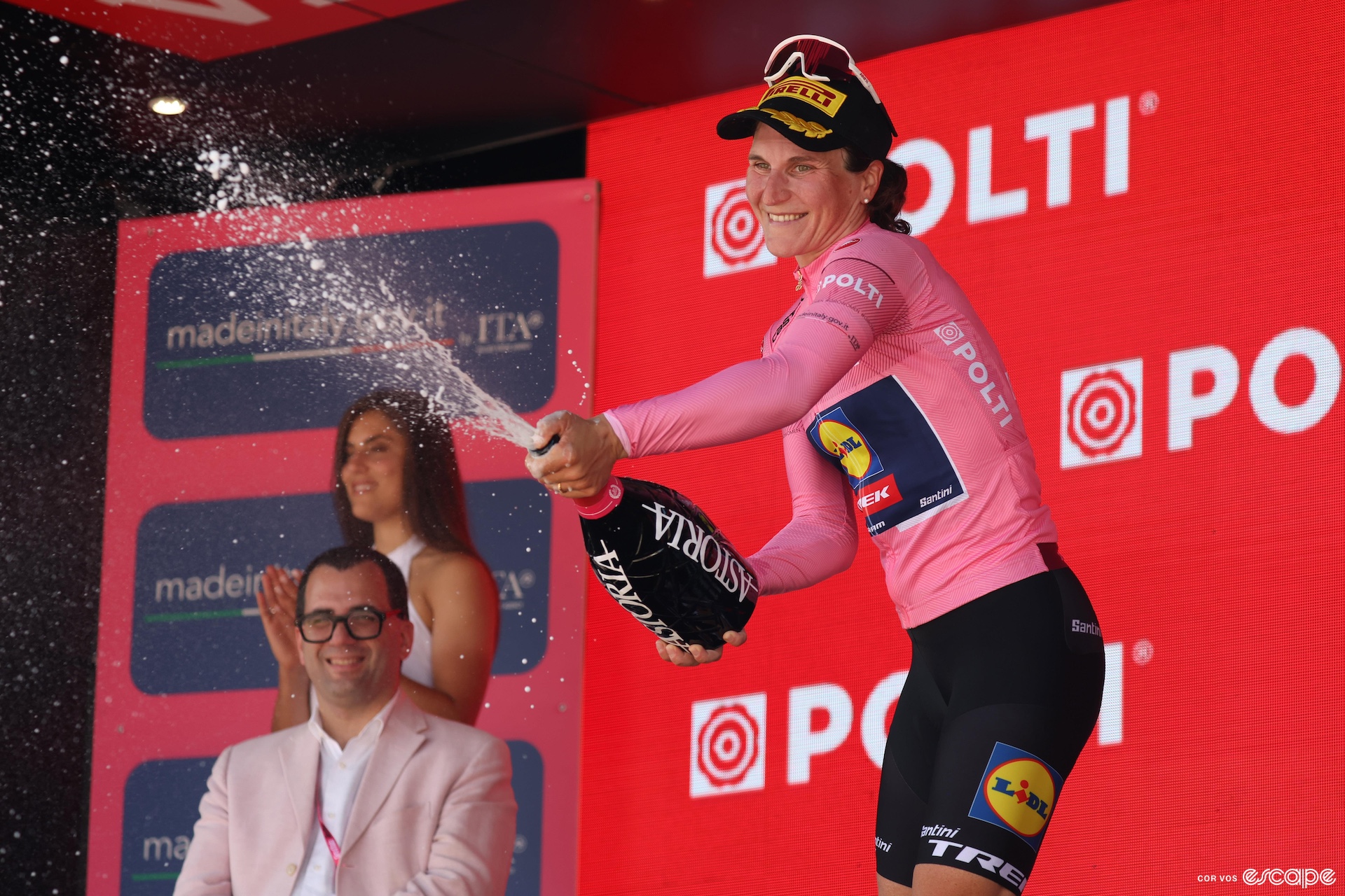 Longo Borghini sprays prosecco while wearing the pink leader's jersey. 