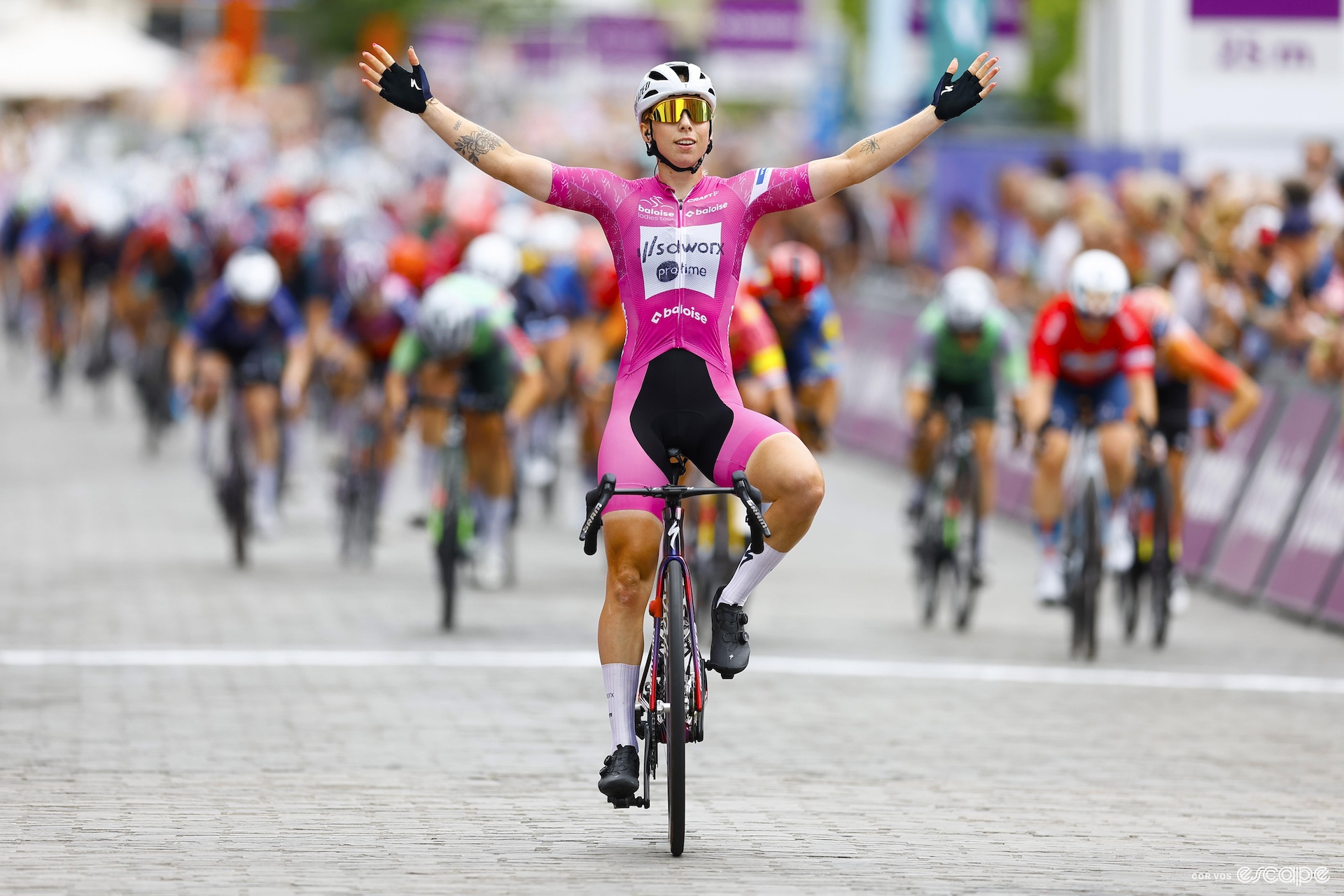 Lorena Wiebes, arms in the air, wins another bike race. 