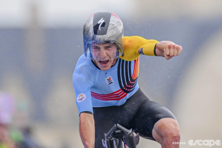 Remco Evenepoel punches the air as he crosses the line to win the Olympic time trial at the Paris Games.