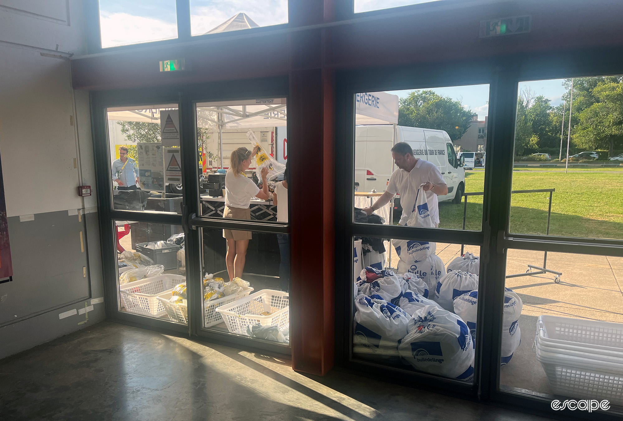 The Tour de France laundry service sorting through clothes.