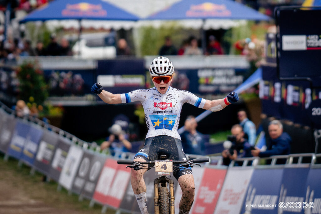 Puck Pieterse, arms thrown wide, roars in celebration on winning World Cup XCO in Les Gets.