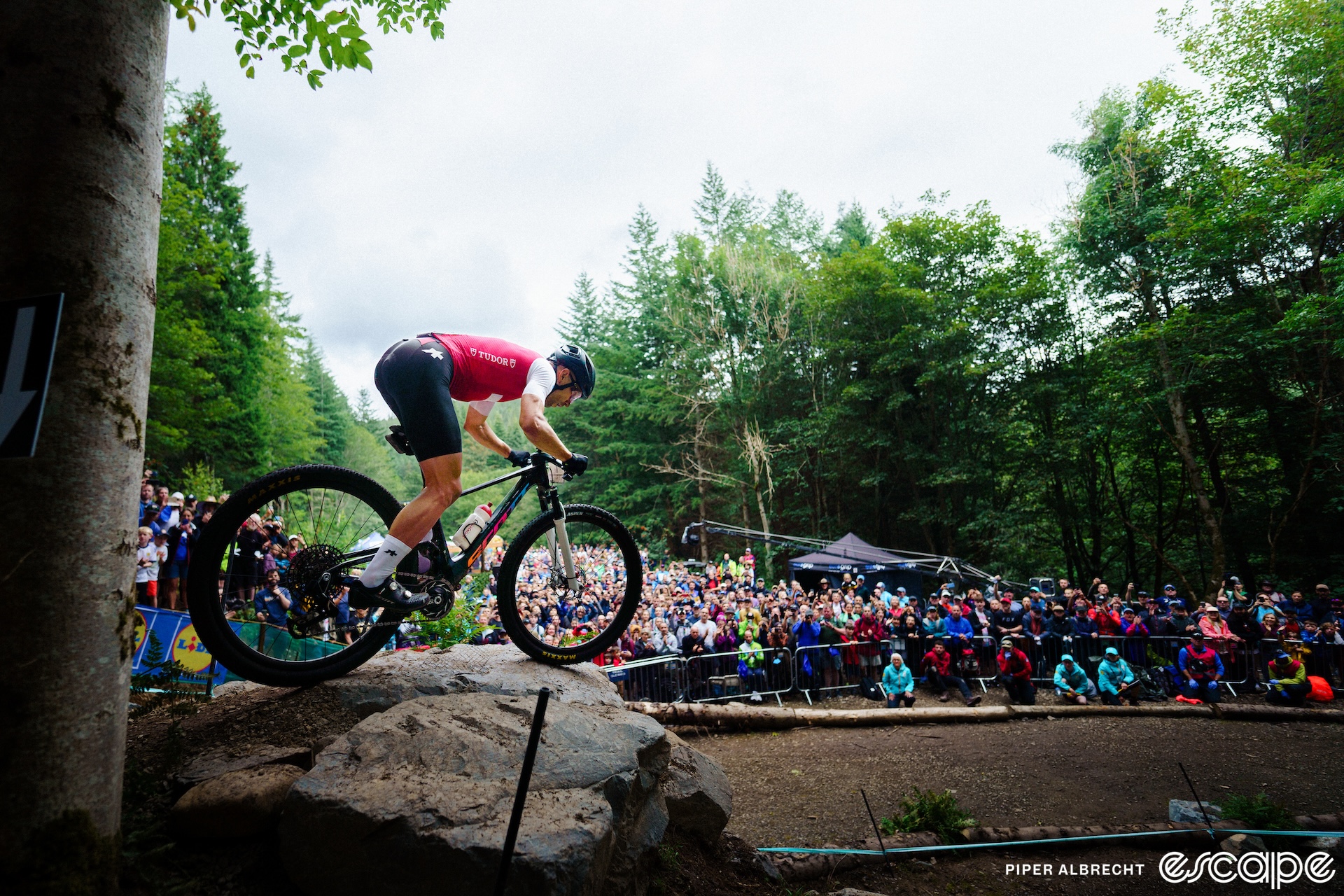 Nino Schurter crouches in attack position as he prepares to launch a rocky drop in front of a huge crowd at the World Championships in Glasgow, Scotland.