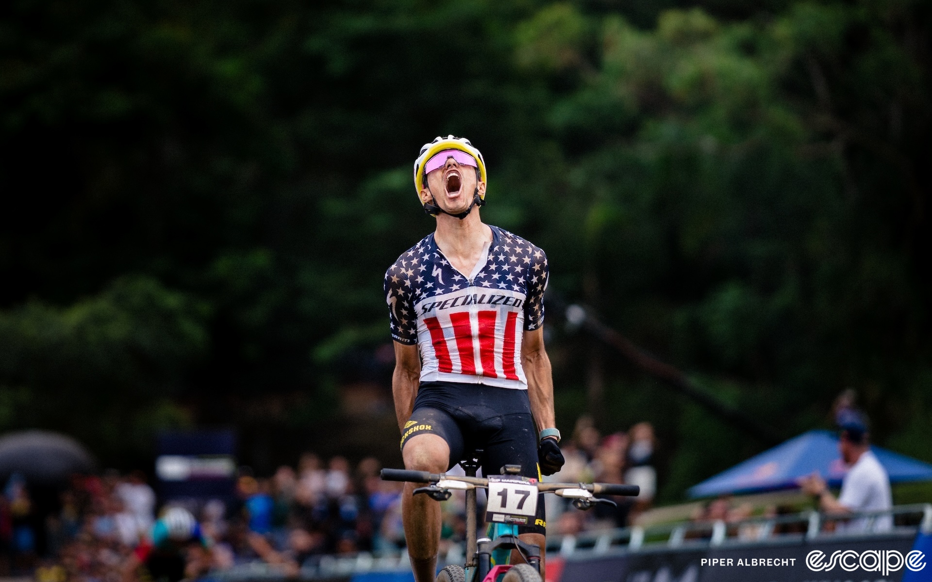 Chris Blevins sits up and punches his hands down at his side as he wins the opening World Cup of the 2024 season. His stars-and-stripes jersey is soaked with sweat and his head is tipped back as he roars in celebration.