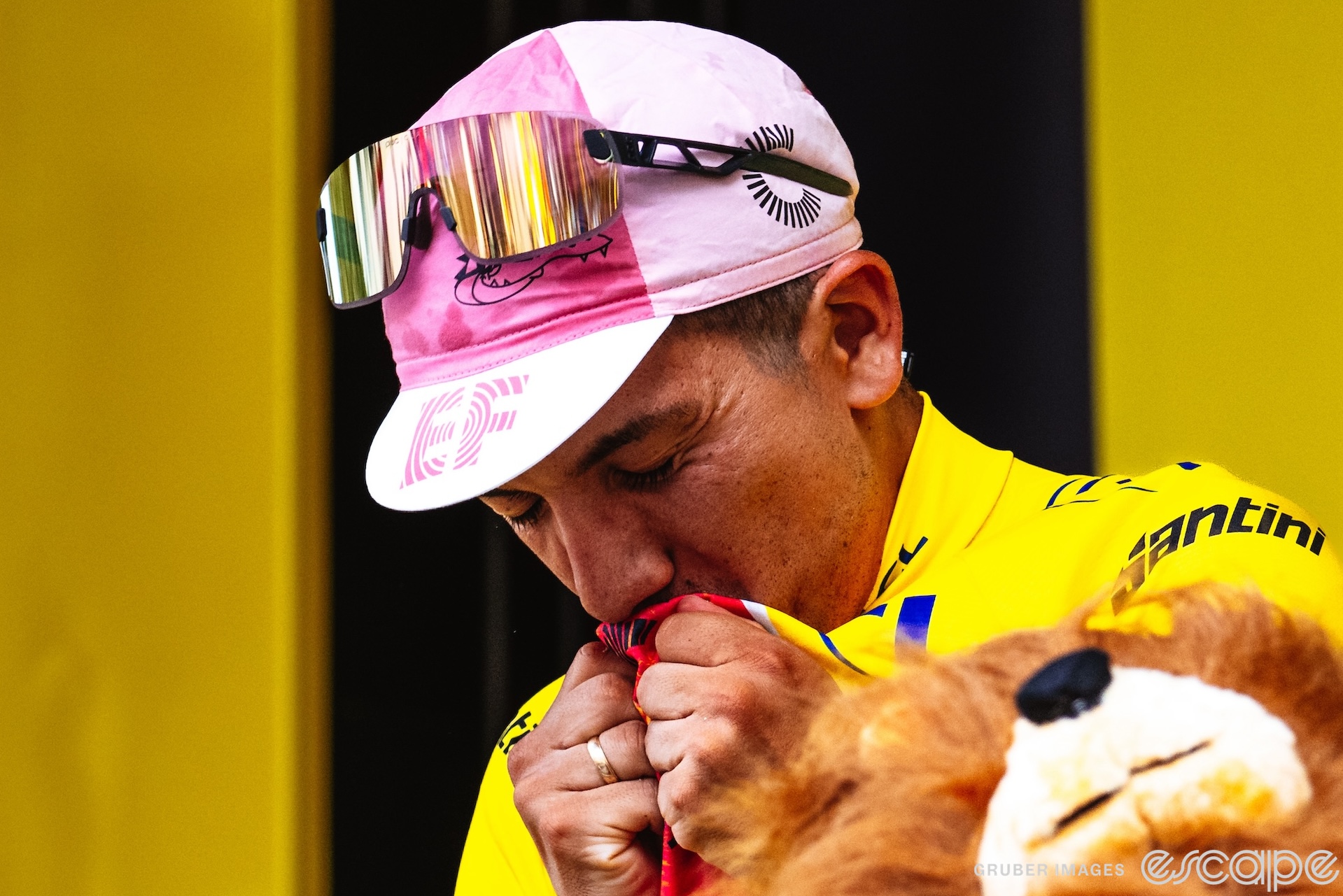 Richard Carapaz closes his eyes and kisses the yellow jersey he's wearing during the podium ceremony after stage 3 of the 2024 Tour de France.