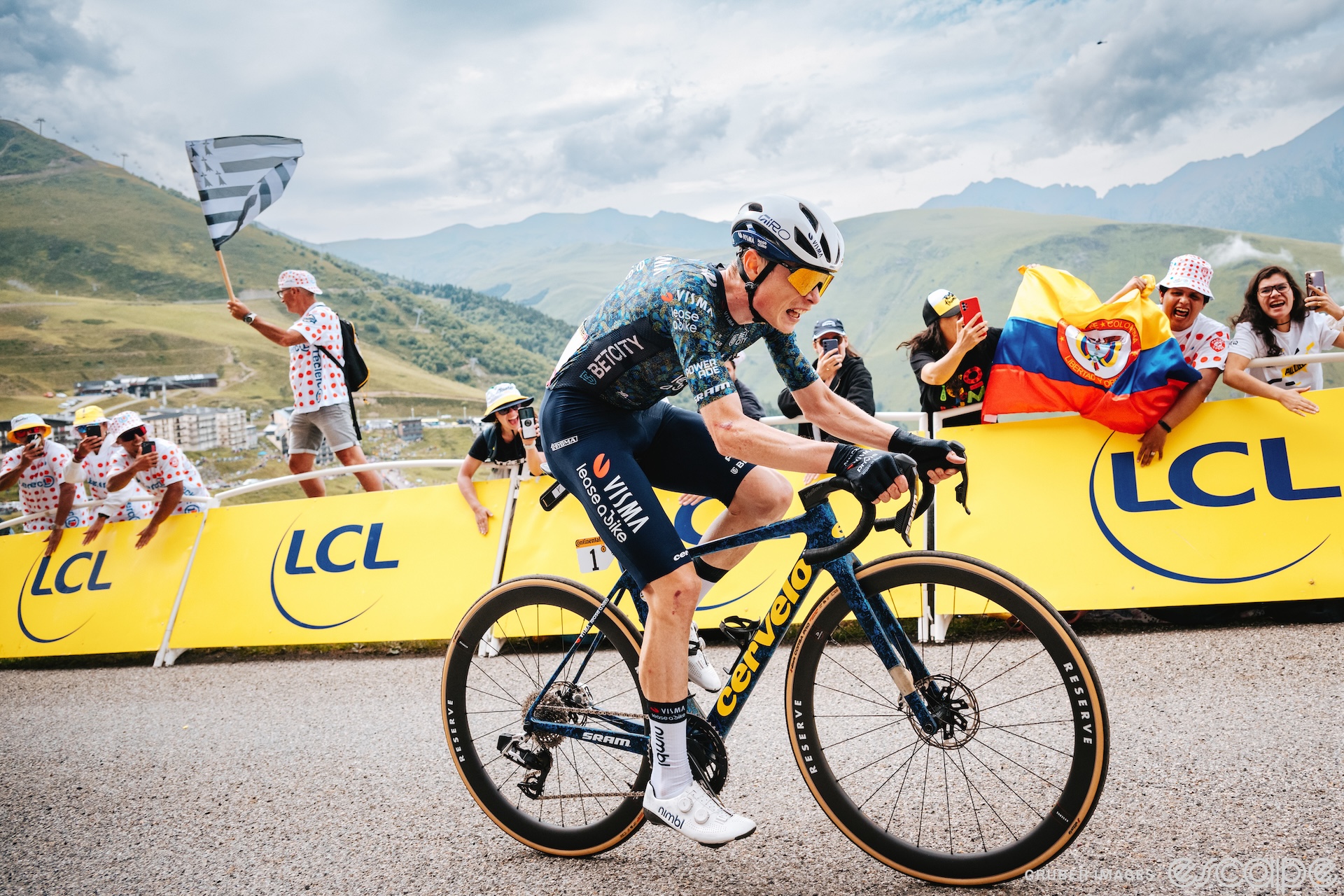 Jonas Vingegaard climbs in the Tour de France. He has a drawn and exhausted expression as he chases Tadej Pogačar, who is unseen.