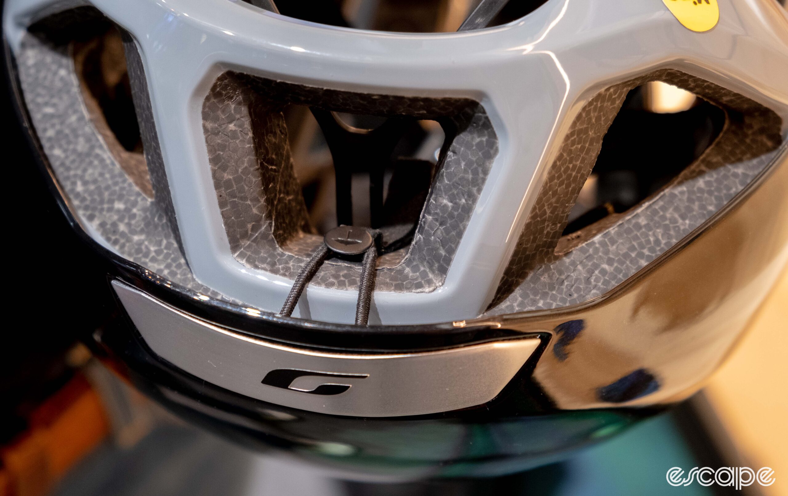 The photo shows the rear of the new Julbo Finisher Evo helmet with a retaining clip for the aero cover.