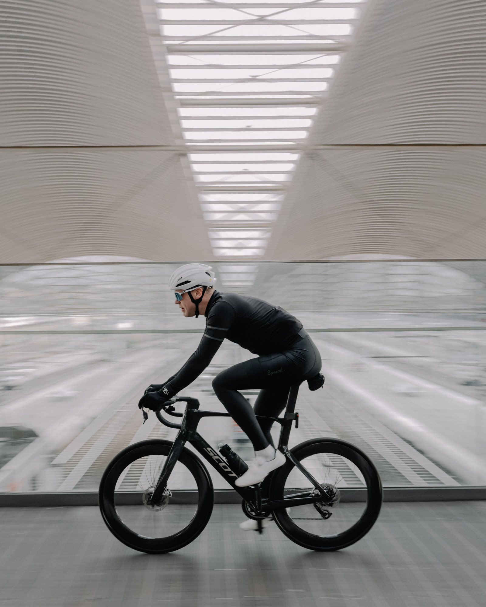 A cyclist⁢ elegantly posed ⁤at a‌ train station.