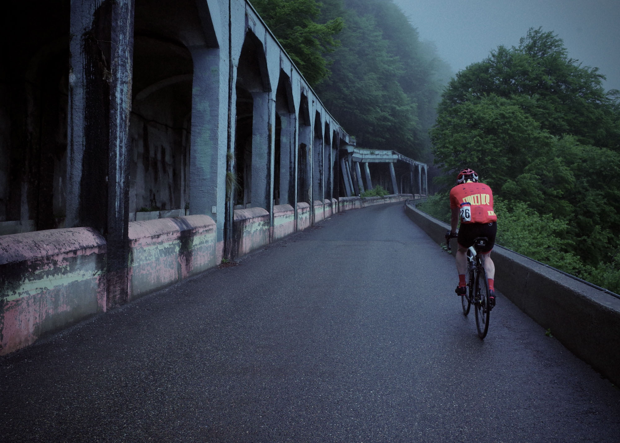 A cyclist ascending a challenging climb.